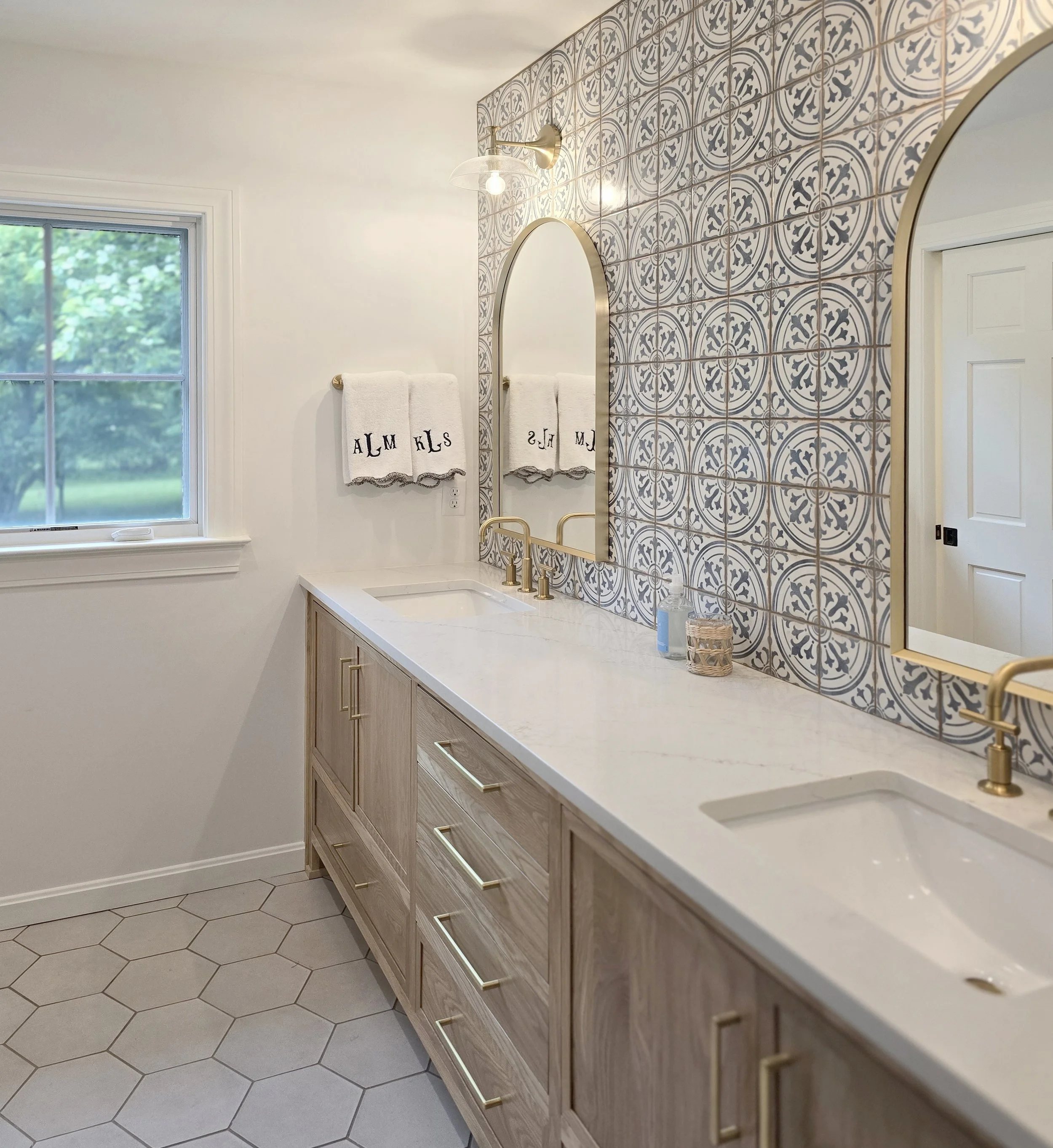 Bedrosians Casablanca Square Tile, Kohler Purist faucet, Kohler essential arched framed bathroom mirror, Kohler Tone One-Light Sconce
