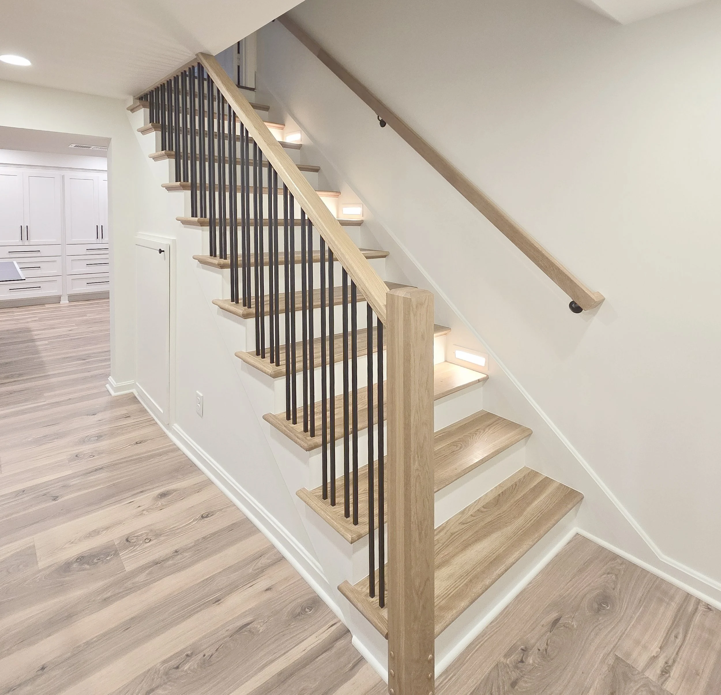 White Oak and Metal Railing, White Oak stair treads, stair lighting, under stair storage,