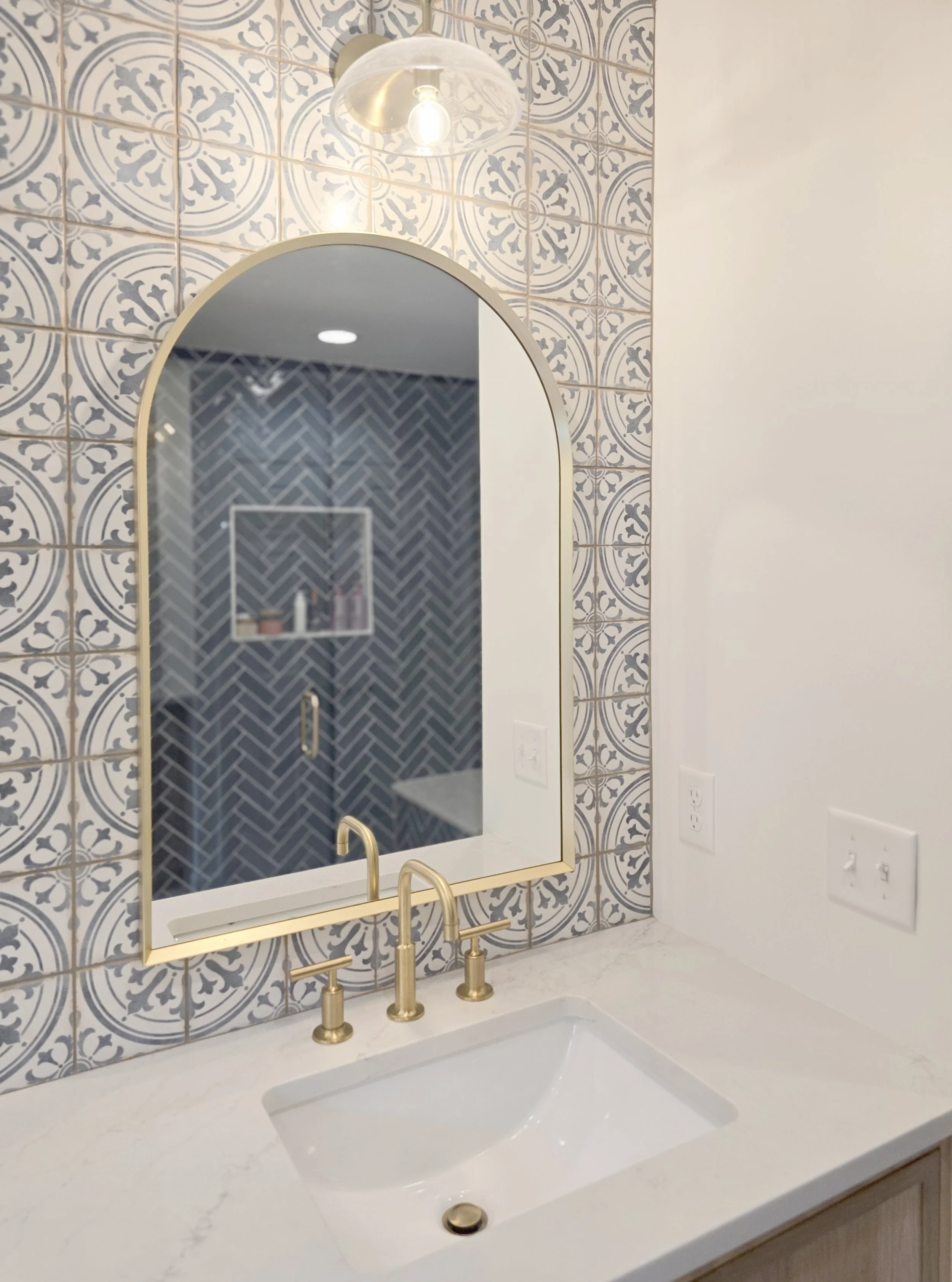 Bedrosians Casablanca Square Tile, Kohler Purist faucet, Kohler essential arched framed bathroom mirror, Kohler Tone One-Light Sconce
