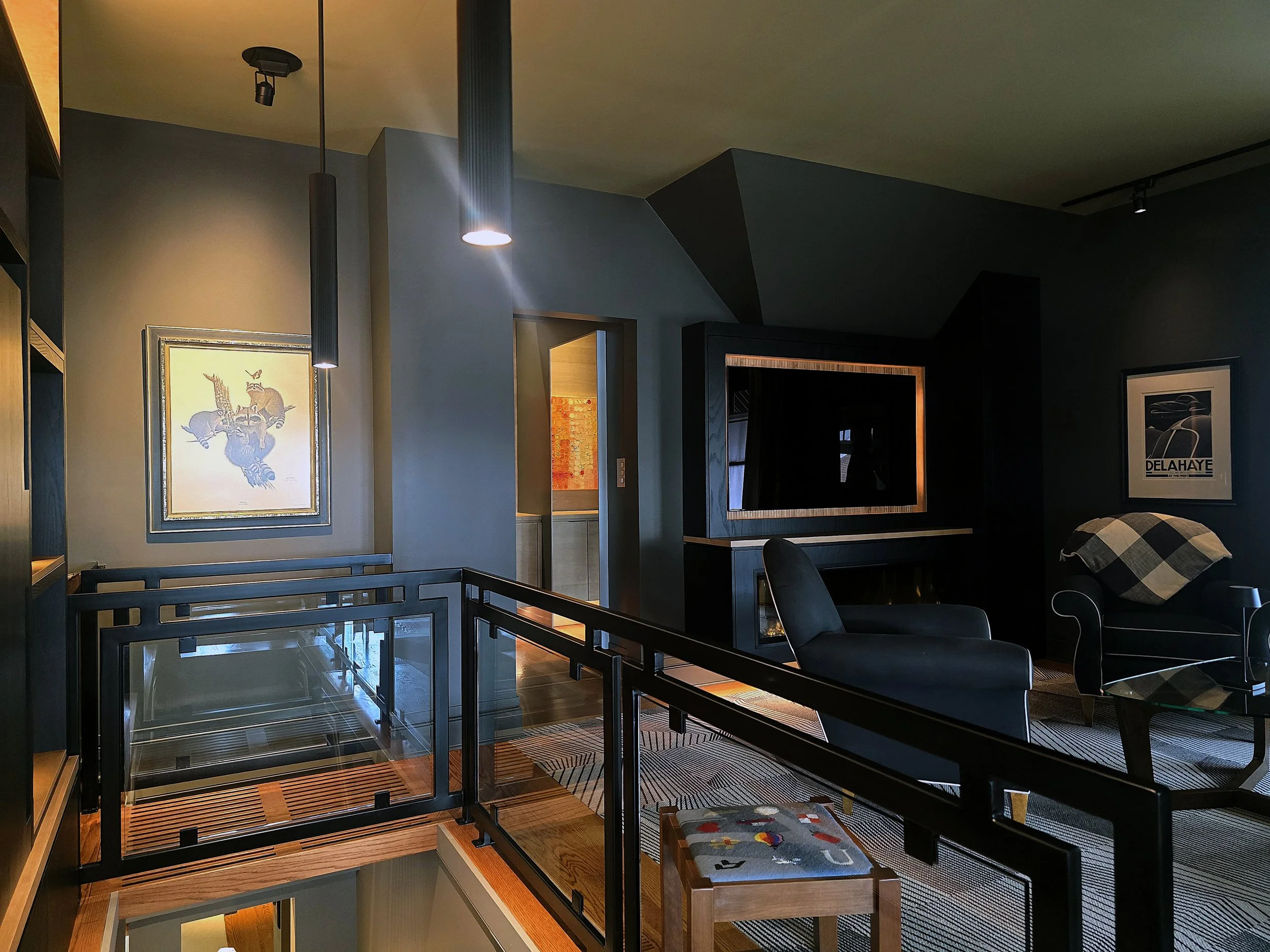 Black tubular metal railing with glass inserts