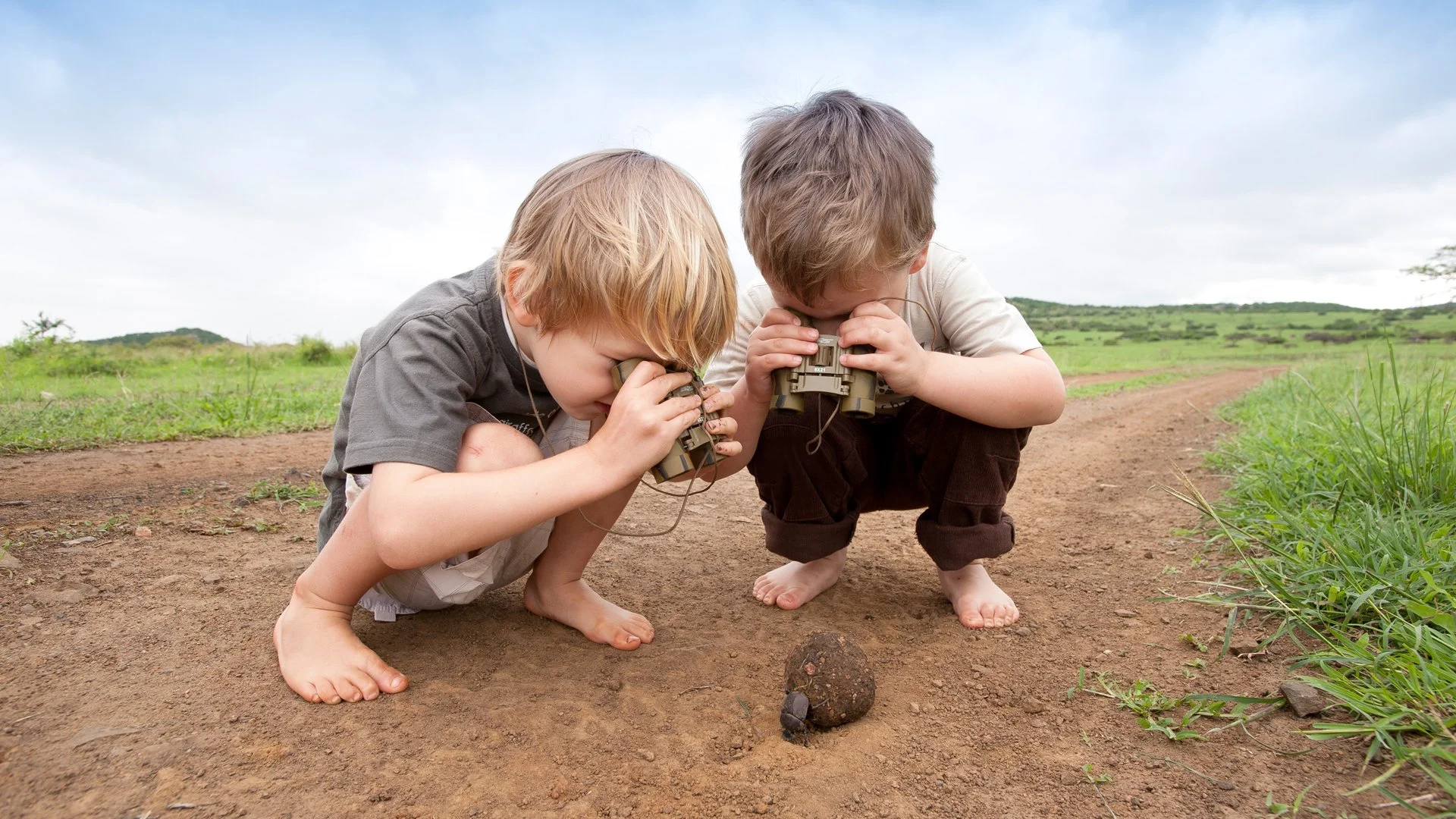 Kids enjoy a close-encoutnter with a dung beetle on safari at Phinda lodge in South Africa