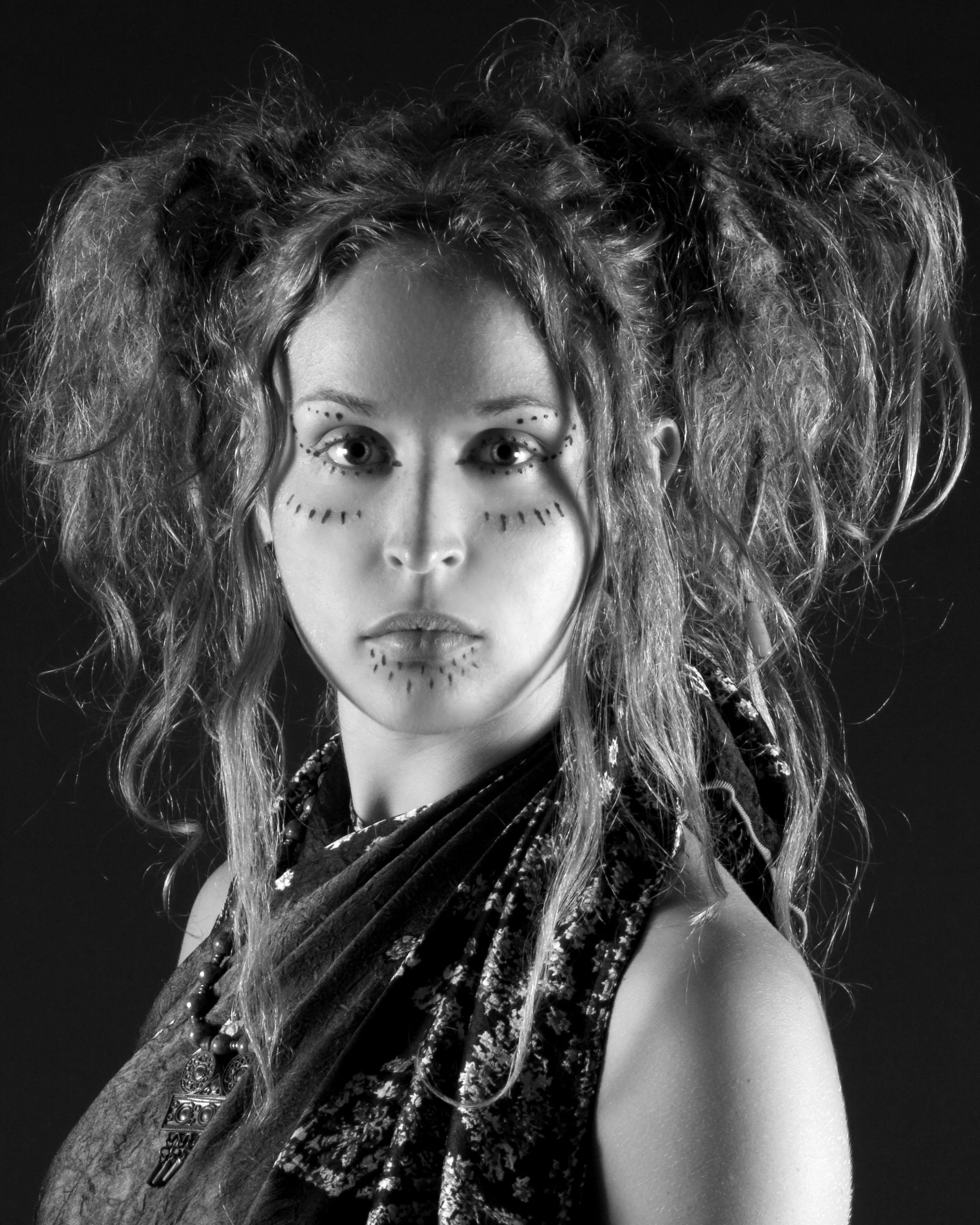 beautiful woman with wild dreadlocks face paint black and white portrait