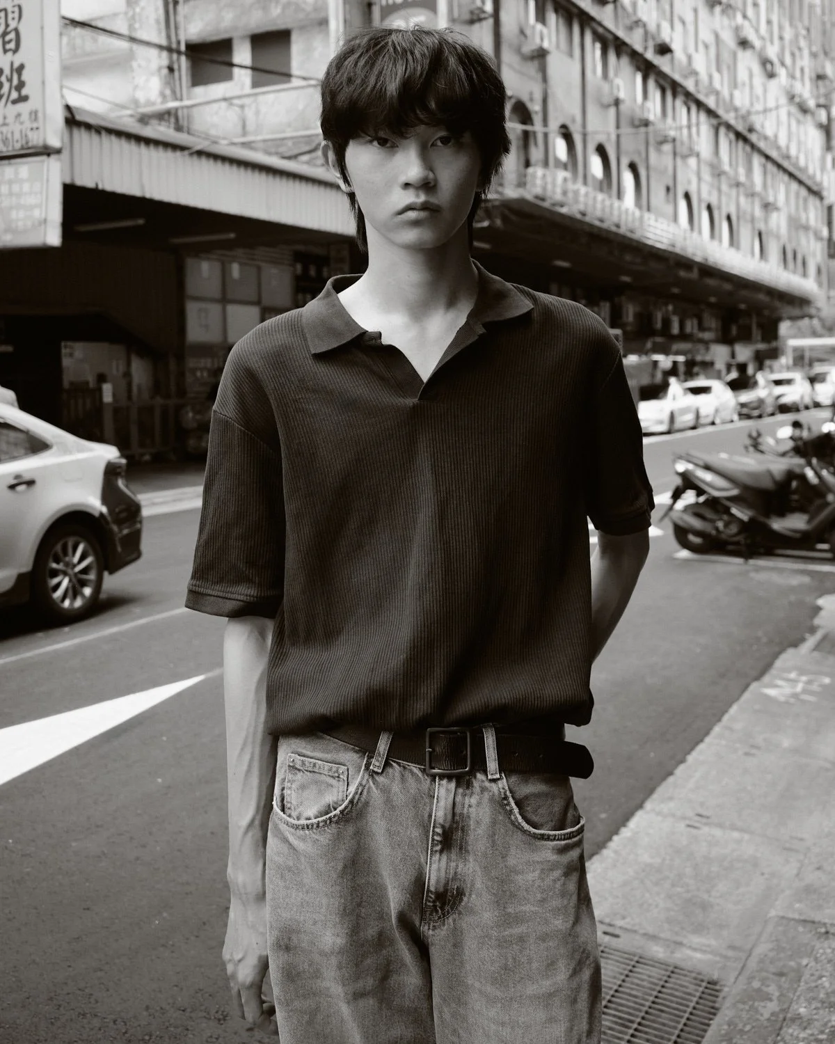 Black and white fashion portrait of a male model on a Taipei city street by Pedro Márnez