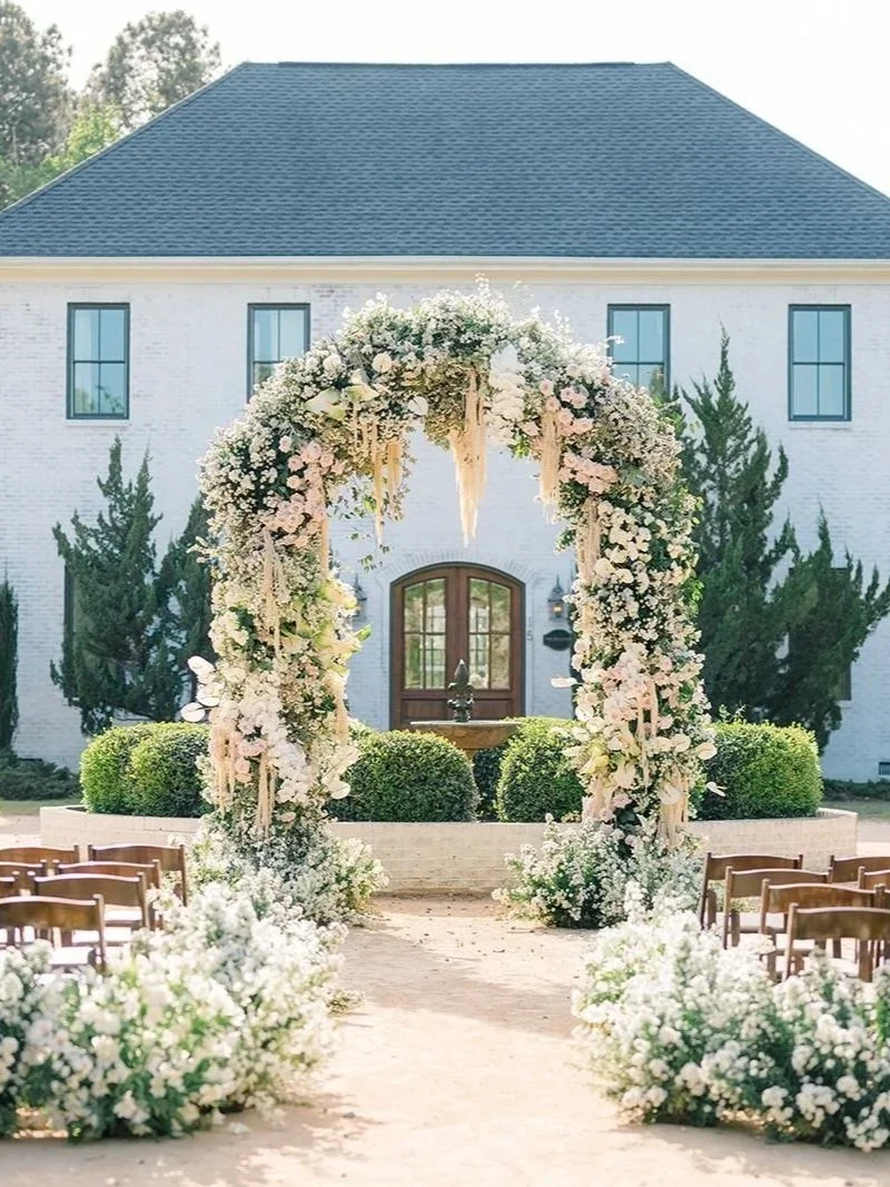 Outdoor wedding ceremony with a large floral arch installation and aisle flowers designed for a luxury New Jersey wedding. New Jersey Florist.
