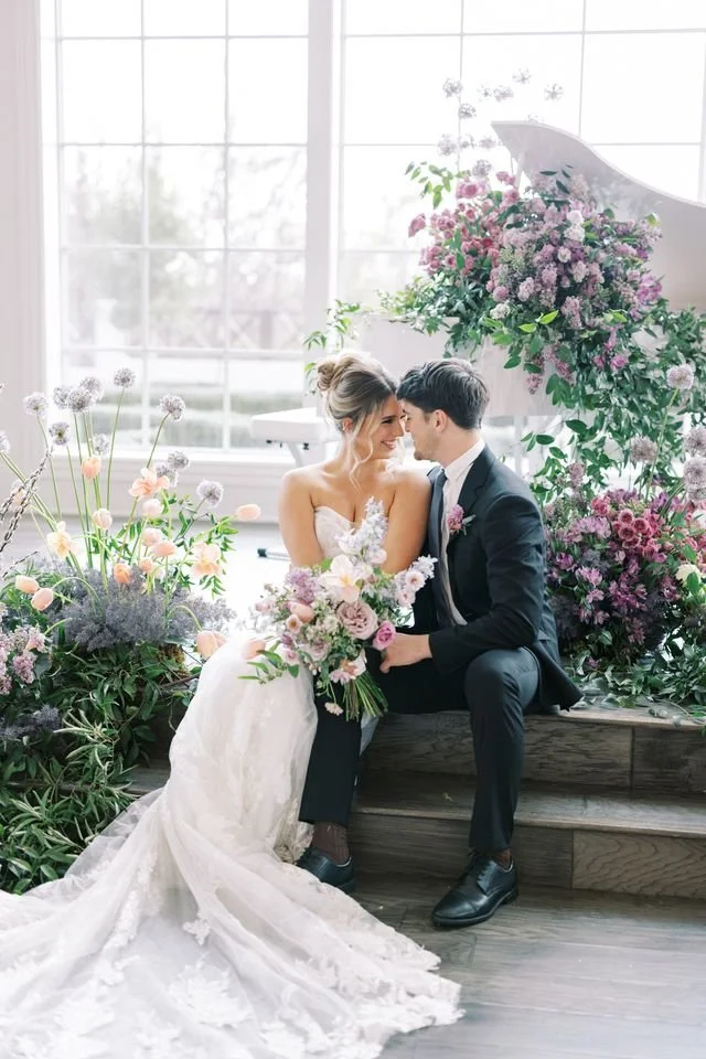 Romantic wedding scene with a couple and lush floral designs by a New Jersey and Philadelphia wedding florist