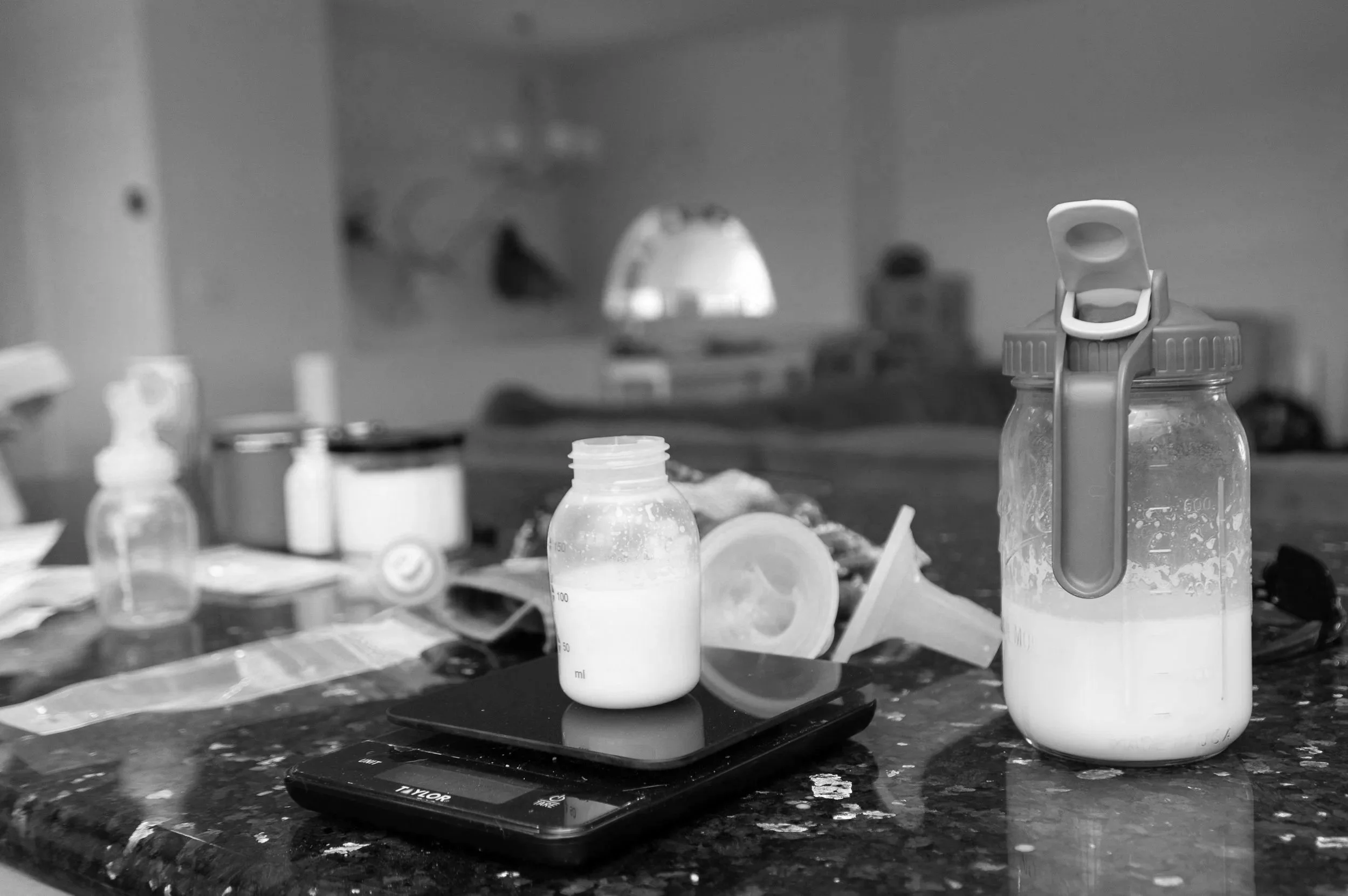 Assorted medical bottles and containers on a cluttered laboratory or medical workspace countertop.