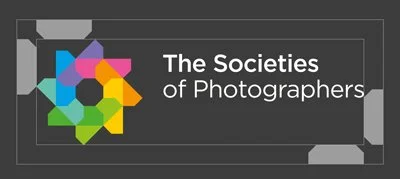 Logo of The Societies of Photographers with a geometric multicolored symbol on a dark background