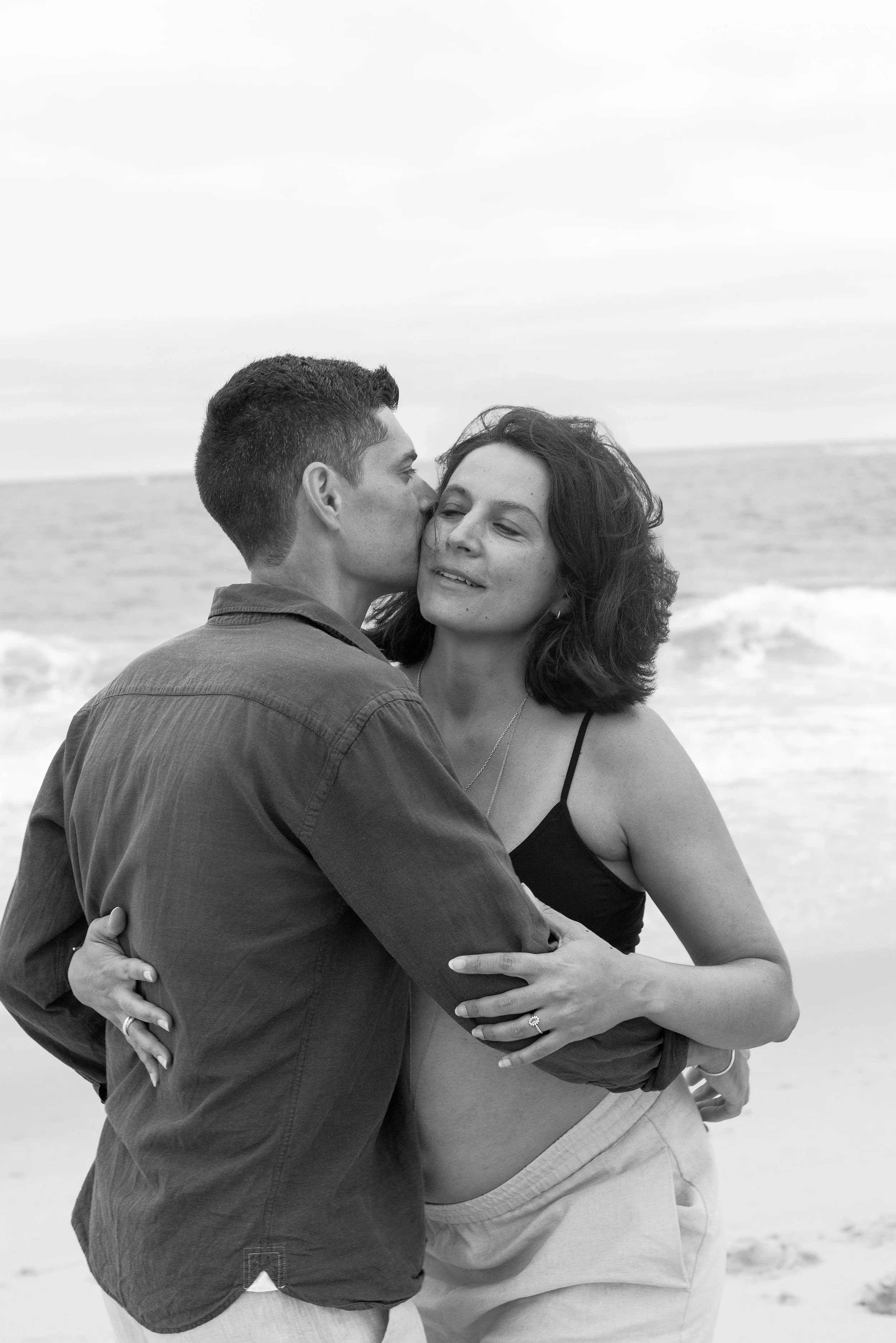 Seance grossesse sensuelle en noir & blanc, un couple devant l'ocean