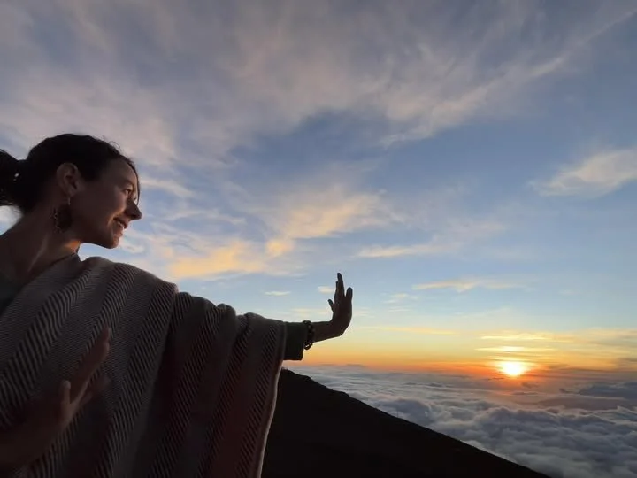 woman reaching toward the sun