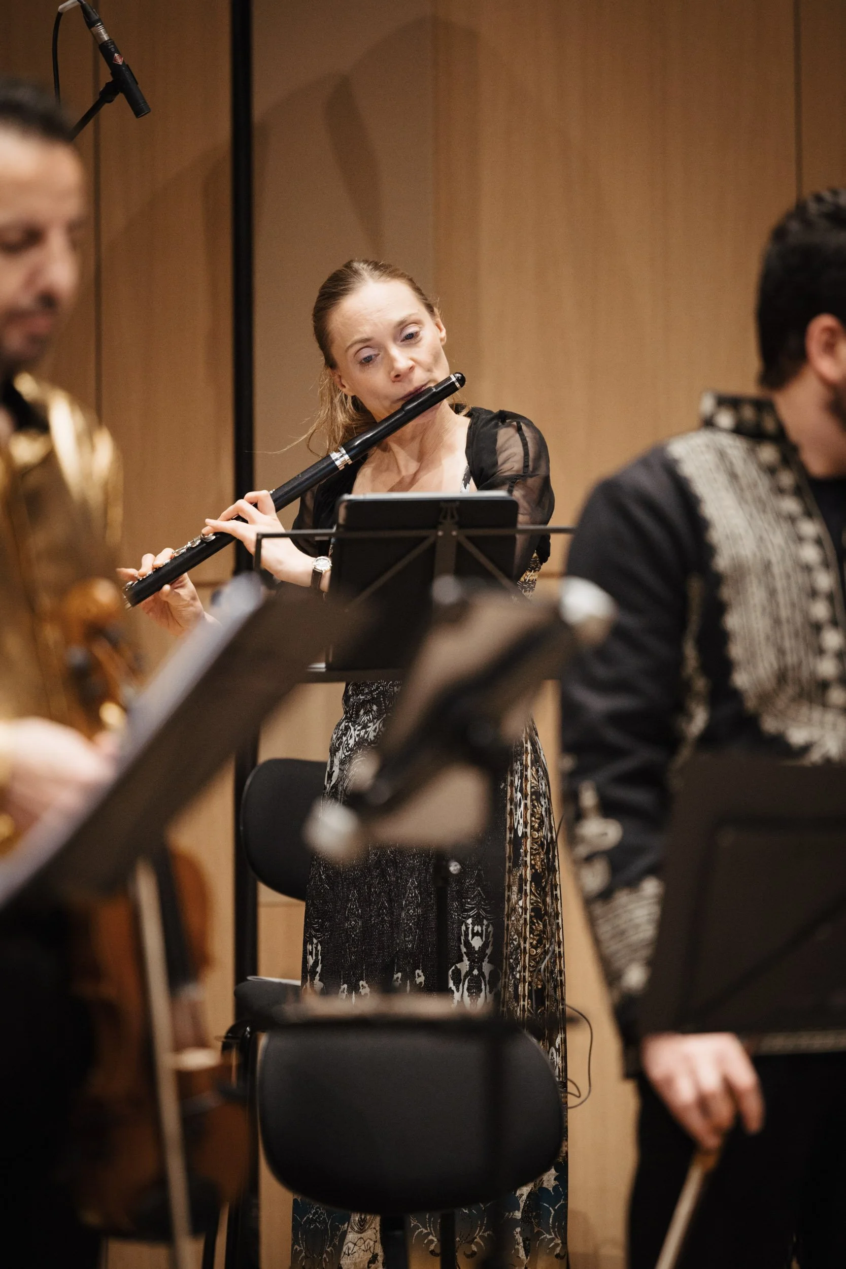 Flute player captured during performance with a chamber orchestra.