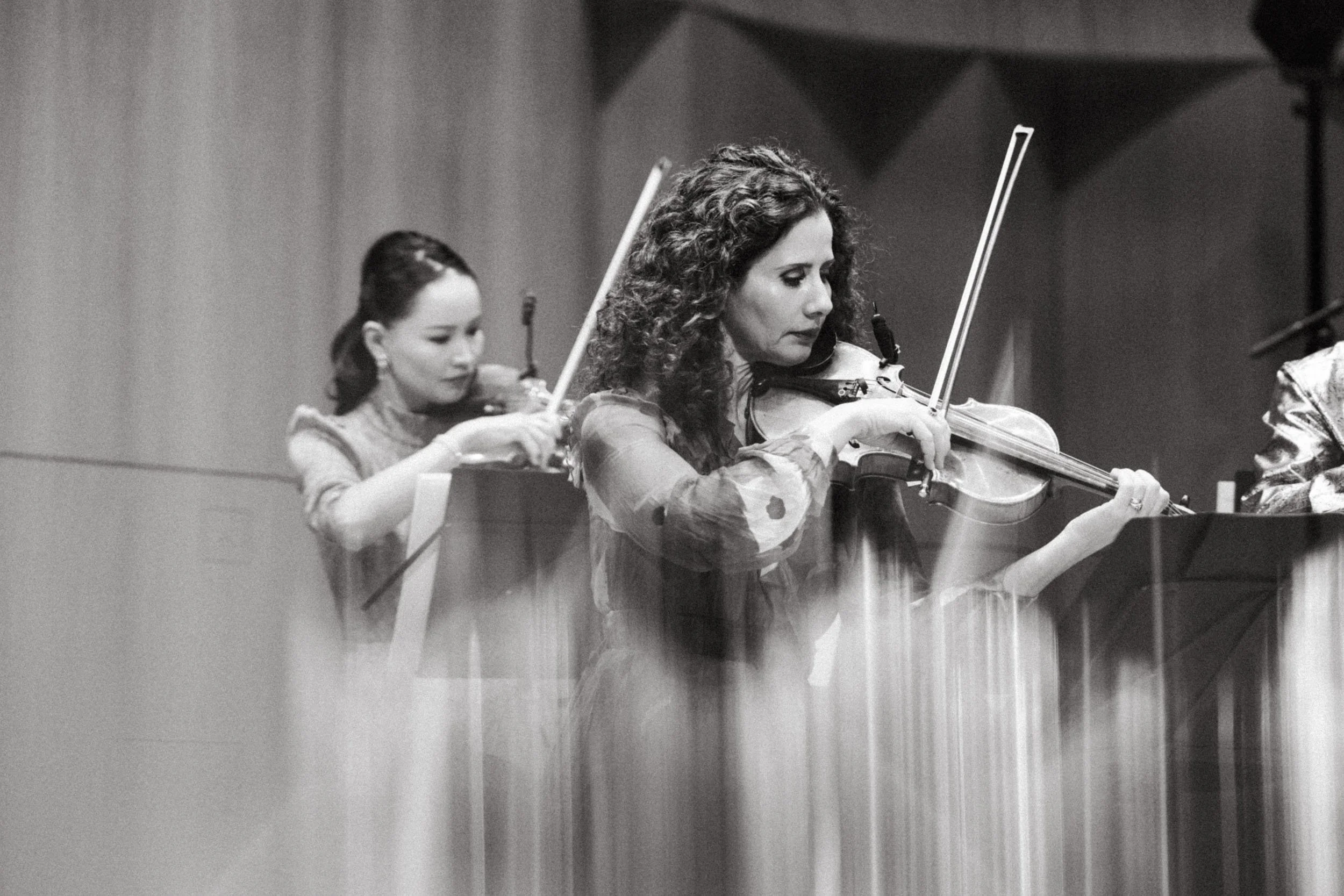 Photo of violinists during musical performance - professional music photography.