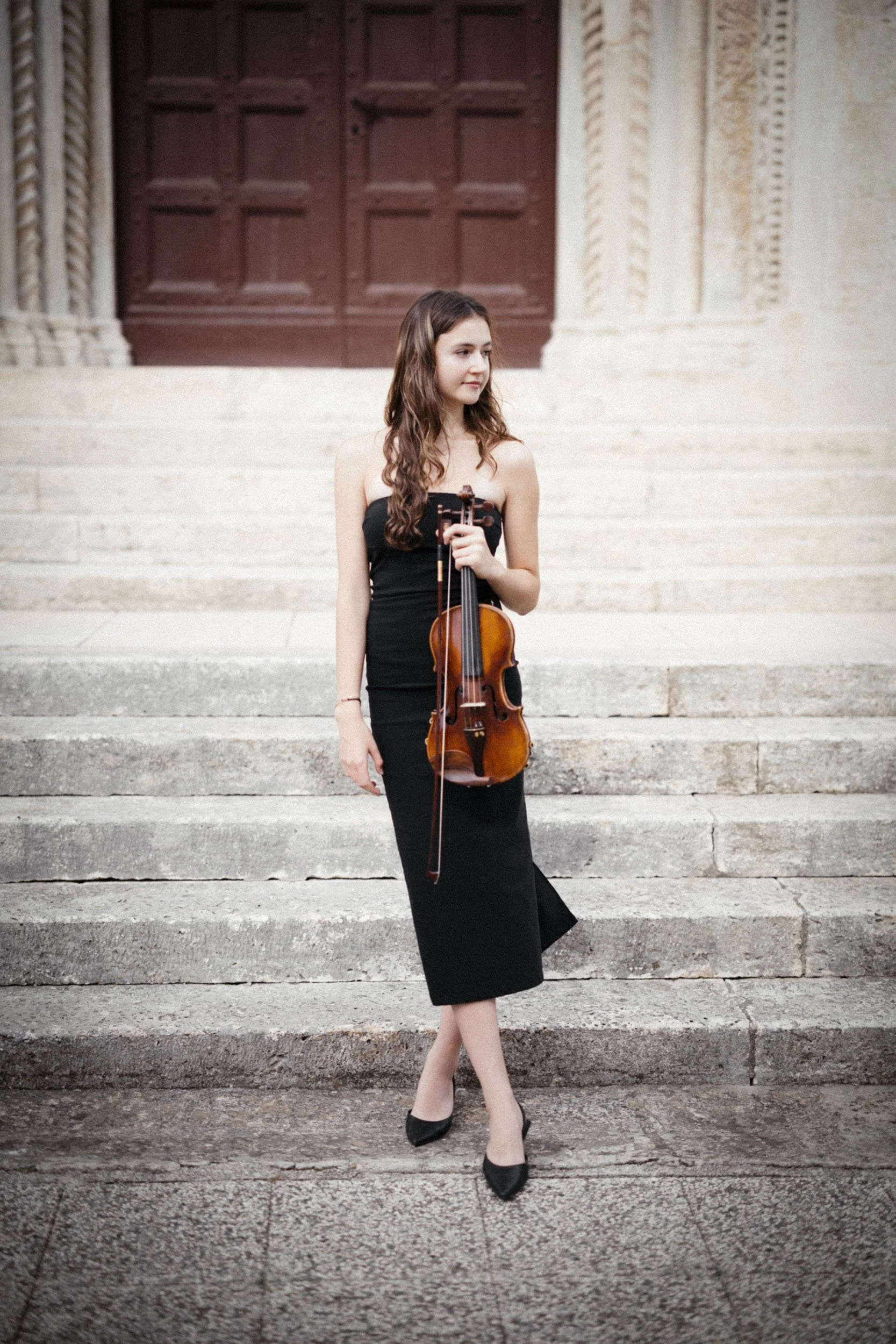 Elegant musician portrait in front of a classical background