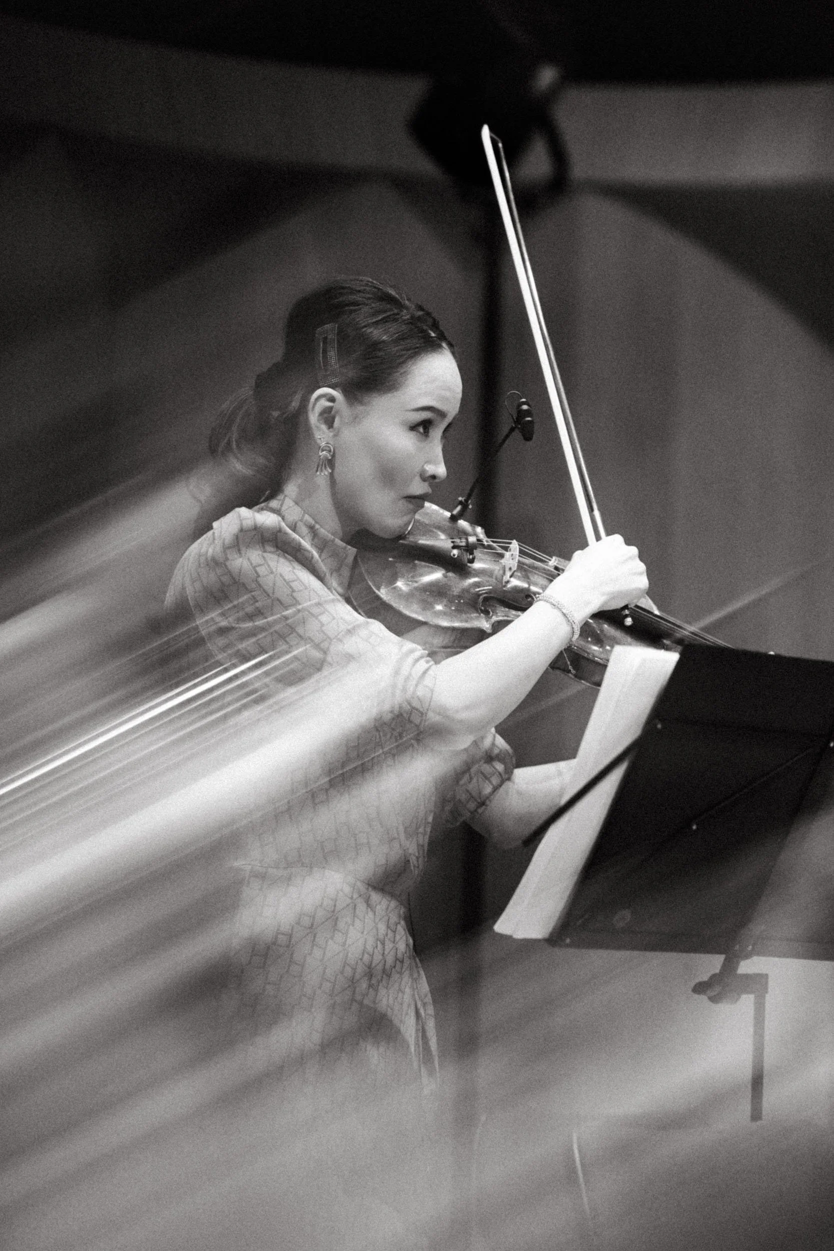 Black and white violinist portrait during classical concert.