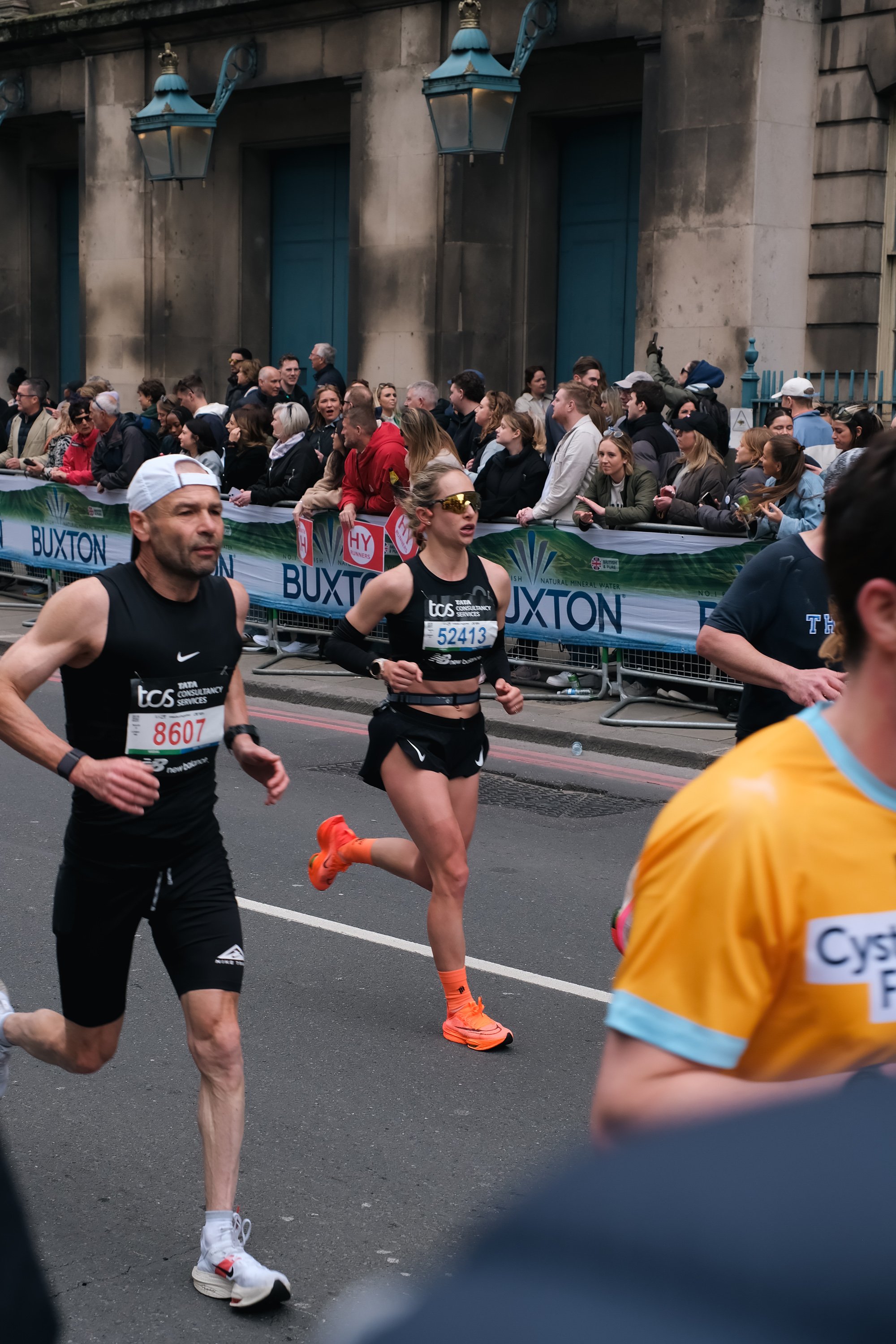 Runners enjoying the festive atmosphere near Big Ben during the London Marathon.