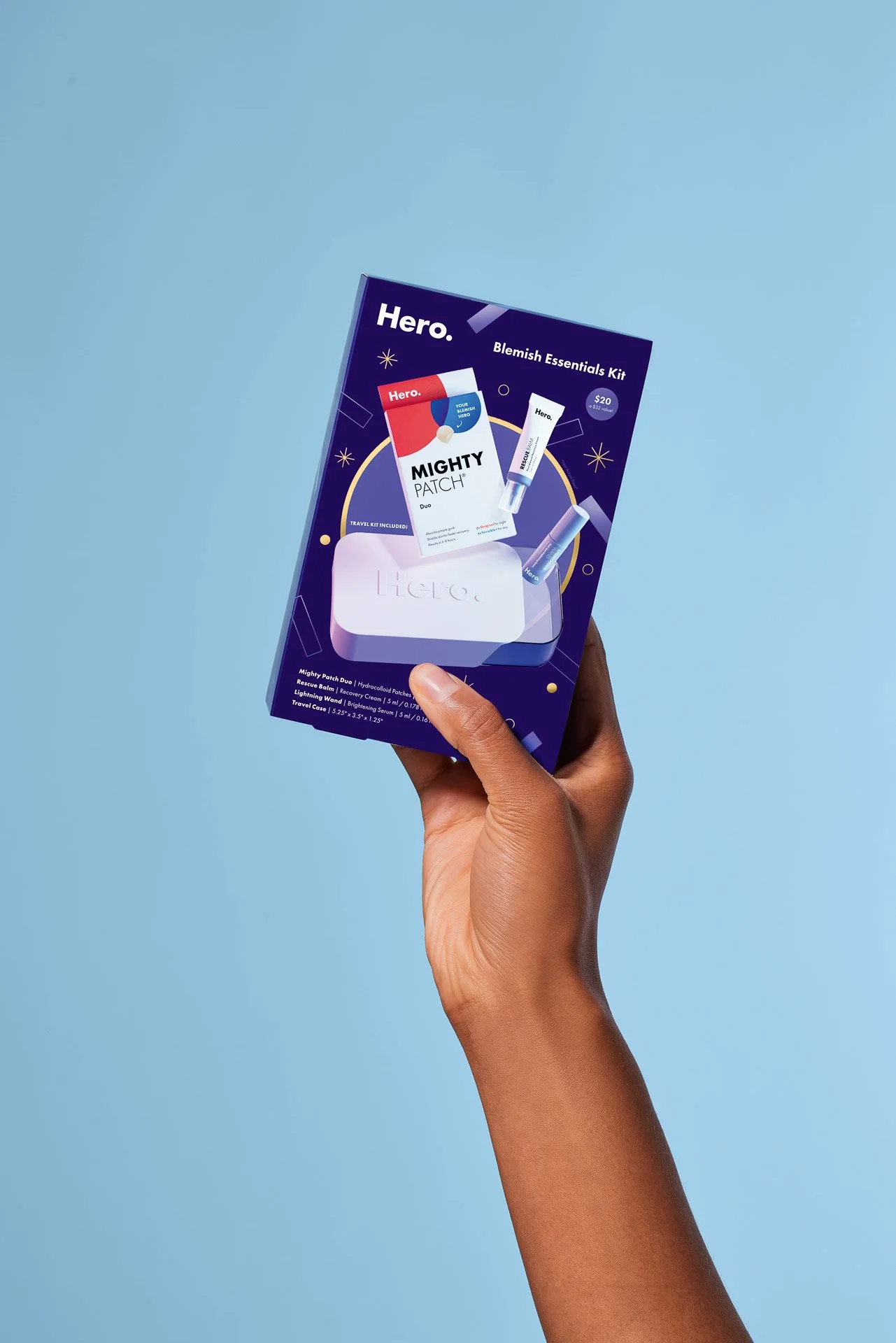 HERO_HOLIDAY2023_27_DTC_KIT_BLEMISH_ESSENTIAL_KIT_BOX_ON_SEAMLESS_WITH_HAND_0040 (original).jpg