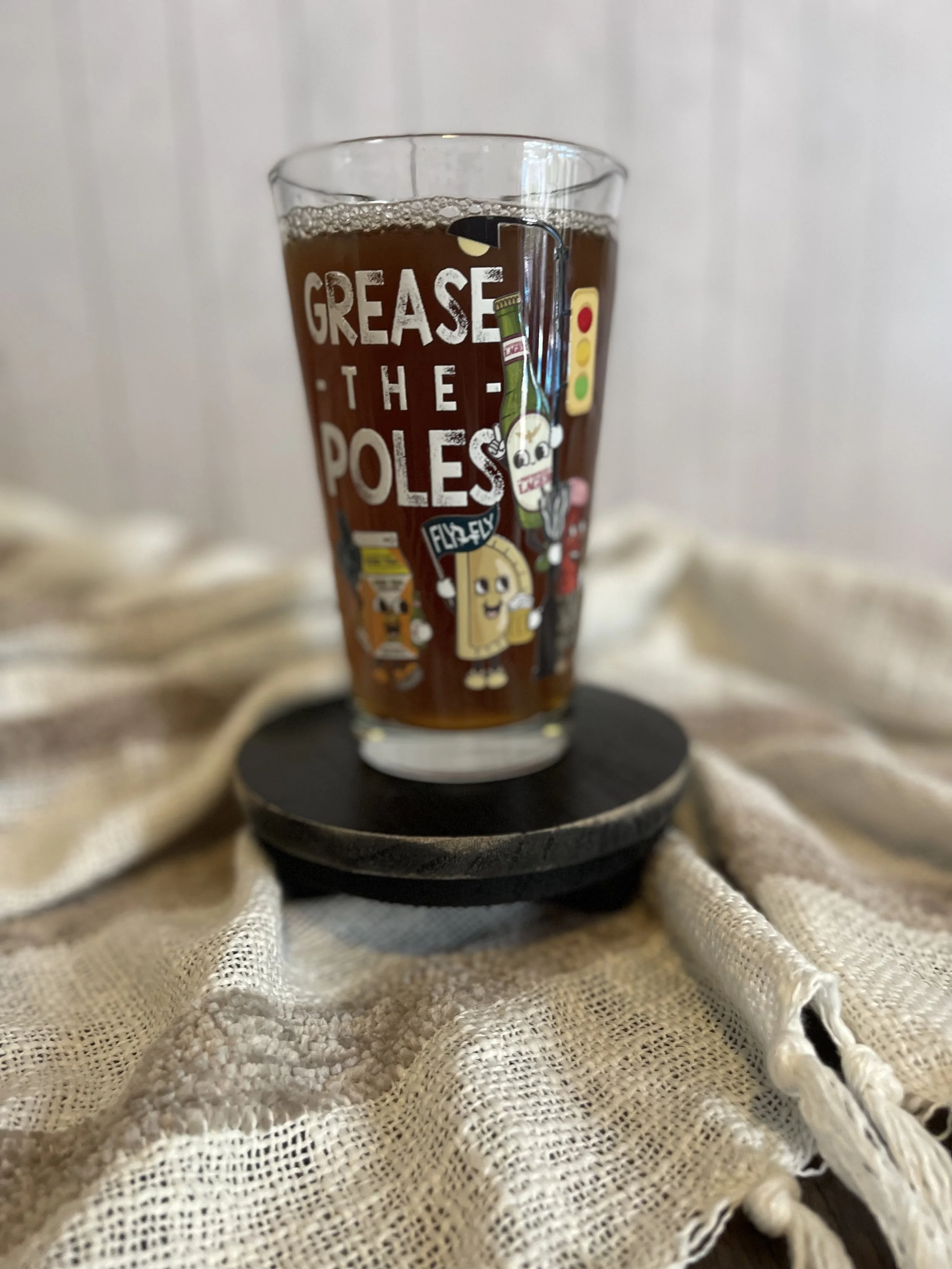 Grease The Poles Pint Glass