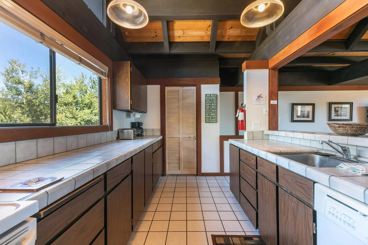 unit 14 kitchen showing cream tile floors and counter tops