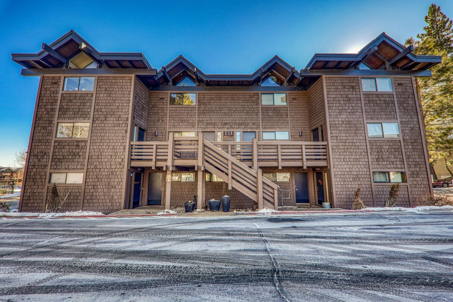 unit 7 exterior two-story building with dark wood shingles