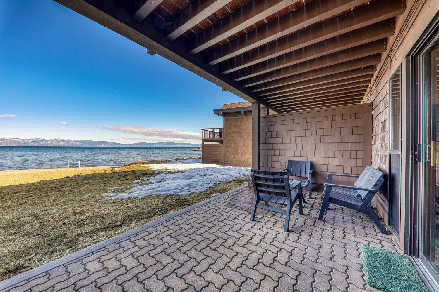 unit 42 covered lower deck with view of lake also shows 3 chairs