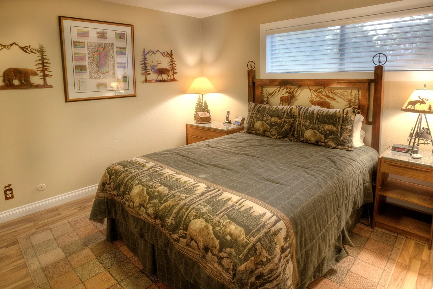 unit 47 master bedroom with king bed and art and headboards featuring elk and bears