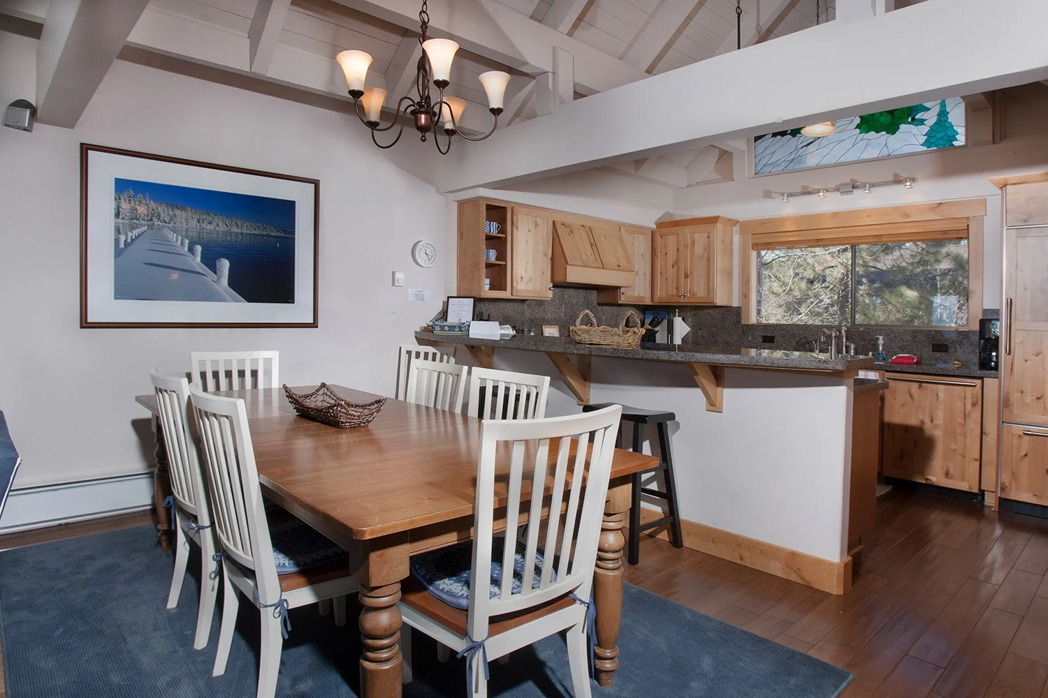 unit 39 dining area showing table and 4 chairs as well as view into kitchen