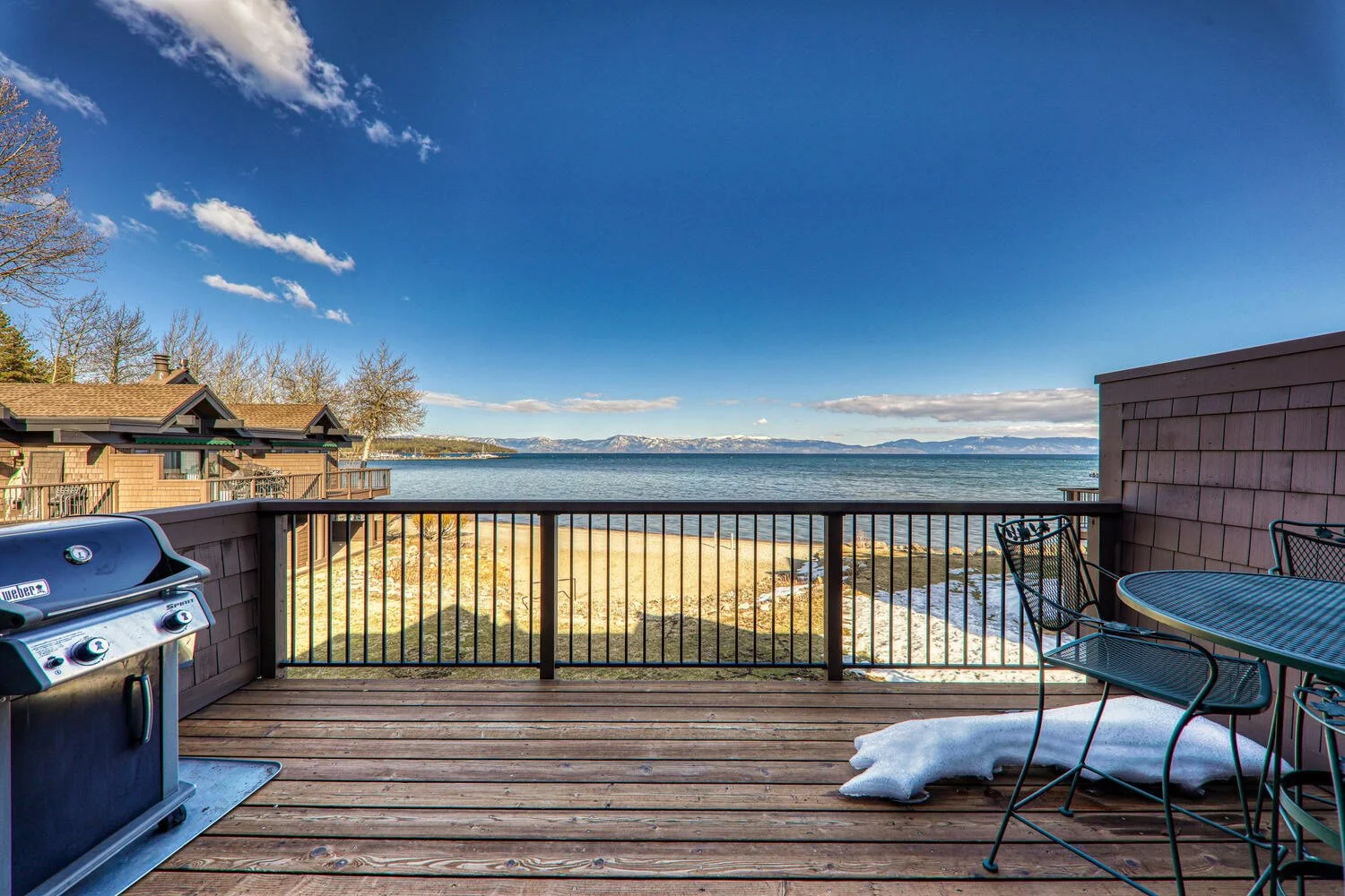 unit 42 upper rear deck with view of lake. some snow on deck.