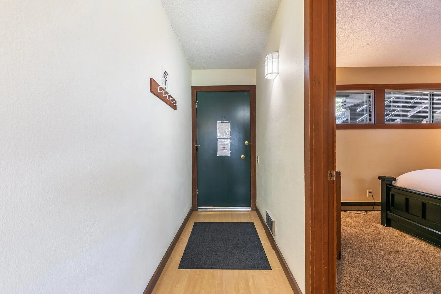 unit 2 view of inside of dark green front door from down hallway