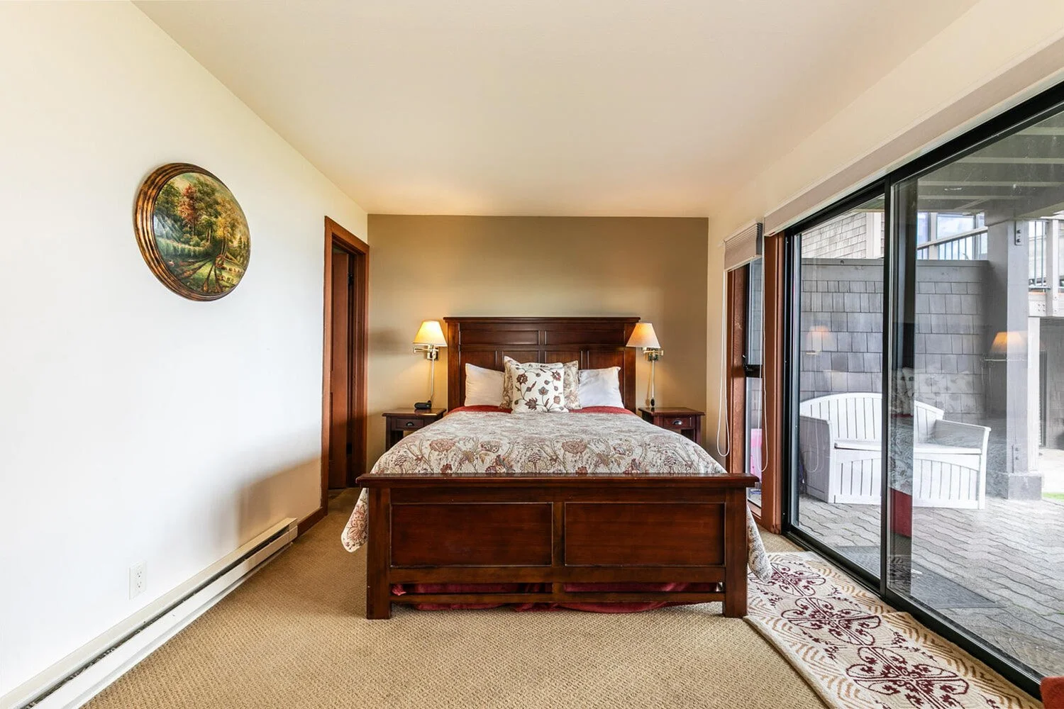 unit 44 master bedroom with dark wood queen bed