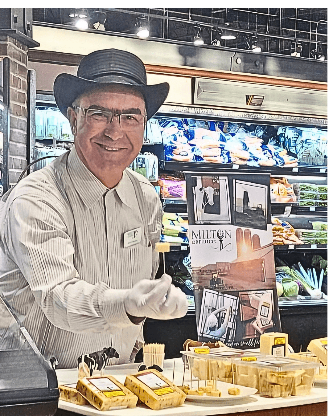 Rufus Musser offers a sample of award-winning Milton Creamery cheese at an outdoor market, capturing the essence of traditional, handcrafted midwestern artisanal products.