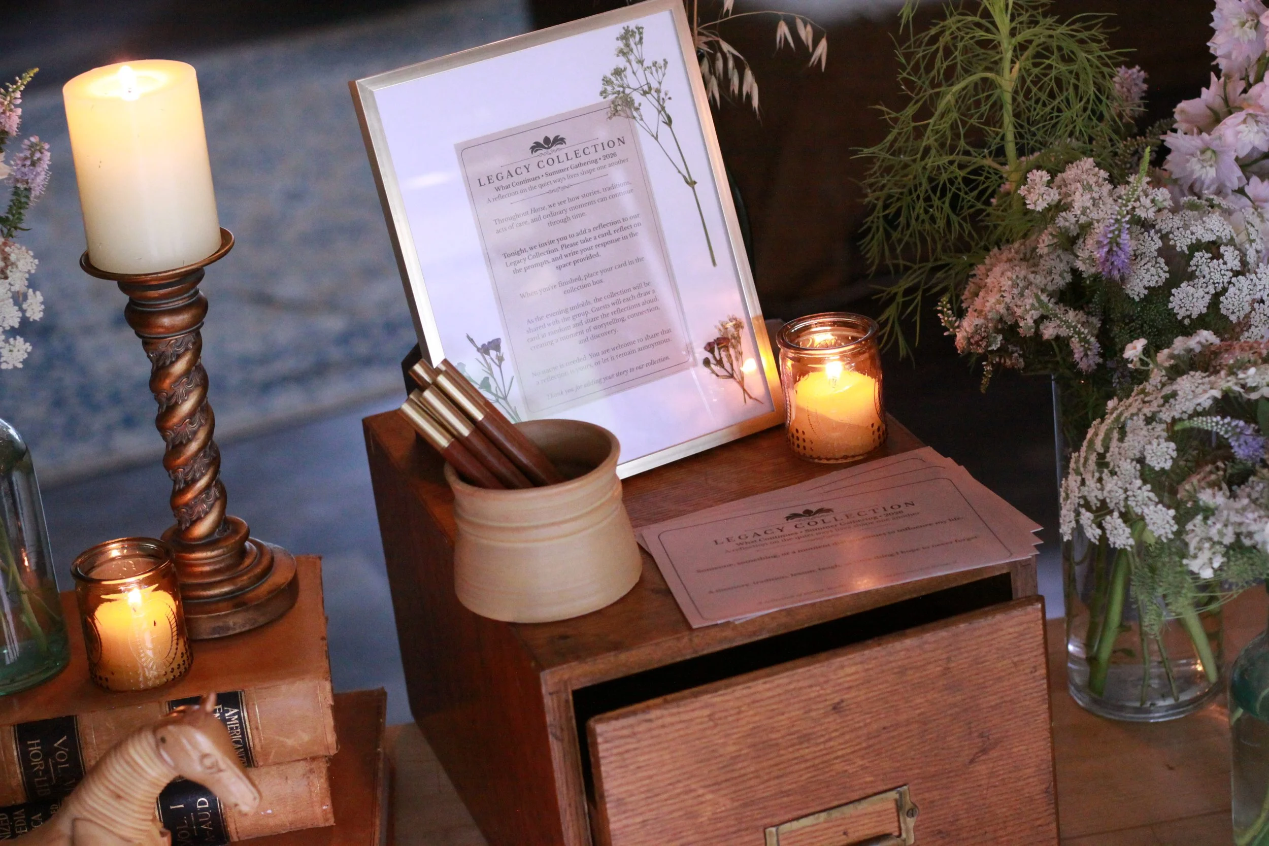 A vintage library box filled with reflection cards, pens, and keepsakes designed to encourage storytelling and connection during an intimate gathering experience.