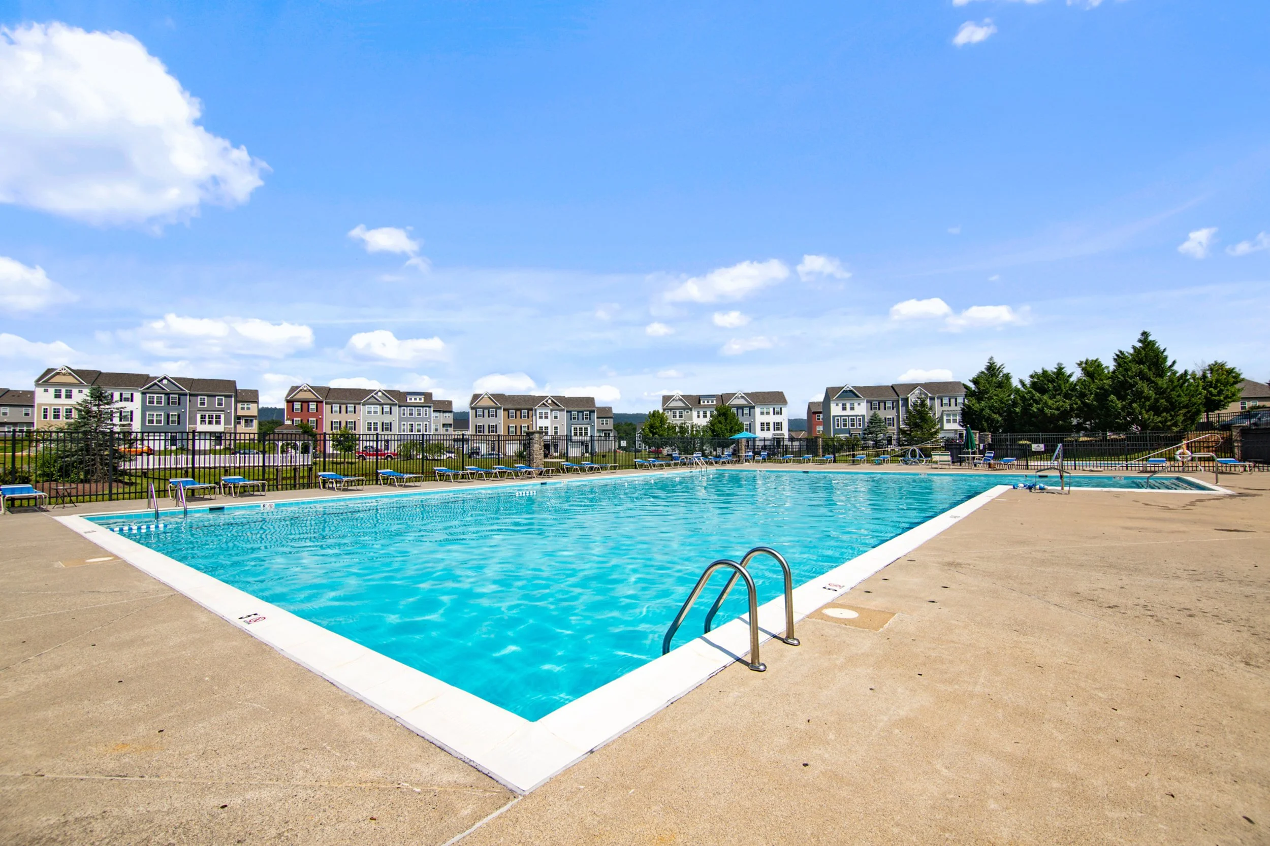 Exterior real estate photography highlighting a community pool in a Martinsburg West Virginia neighborhood