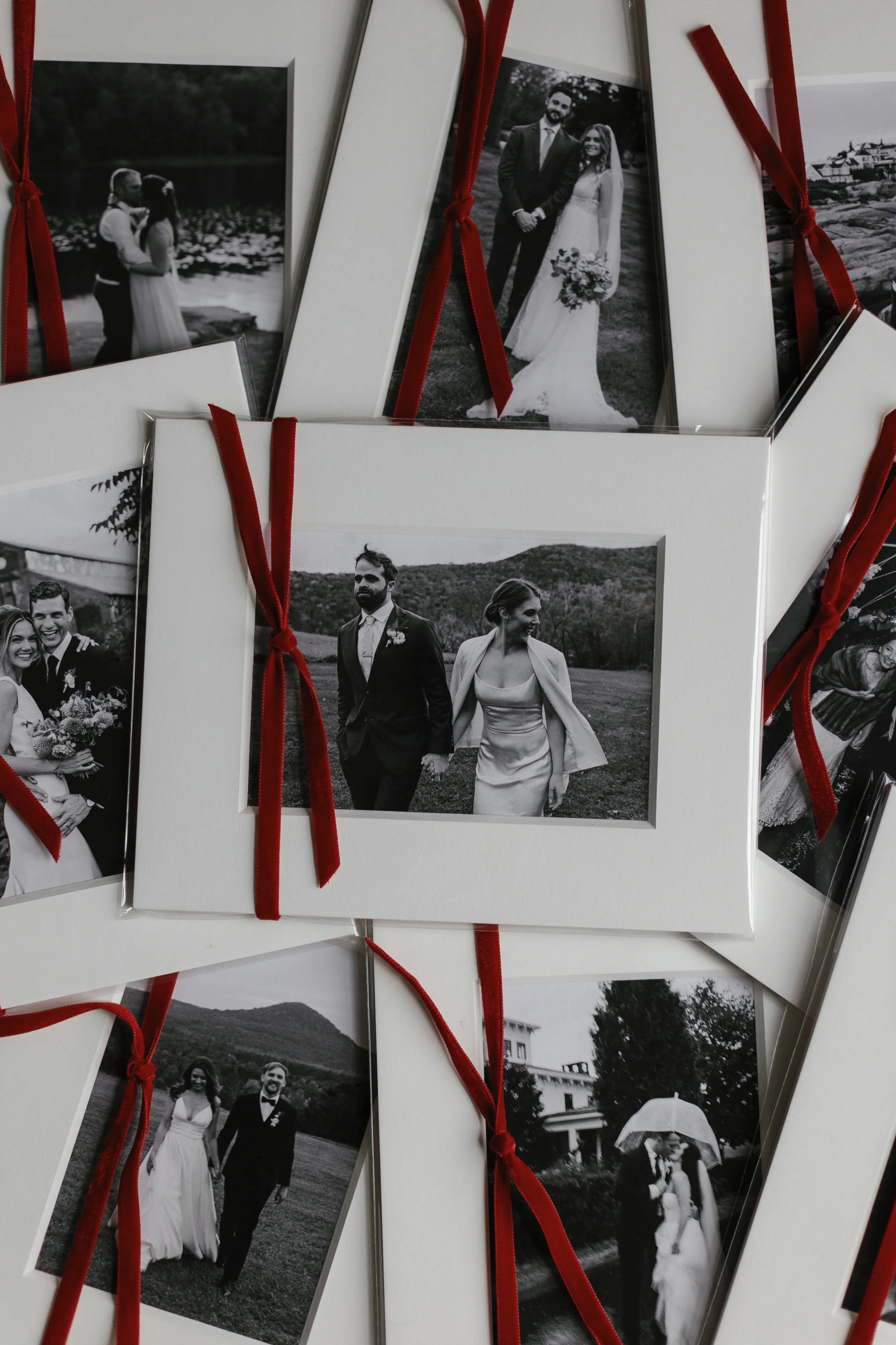 Collection of black and white wedding photographs with red ribbon accents.