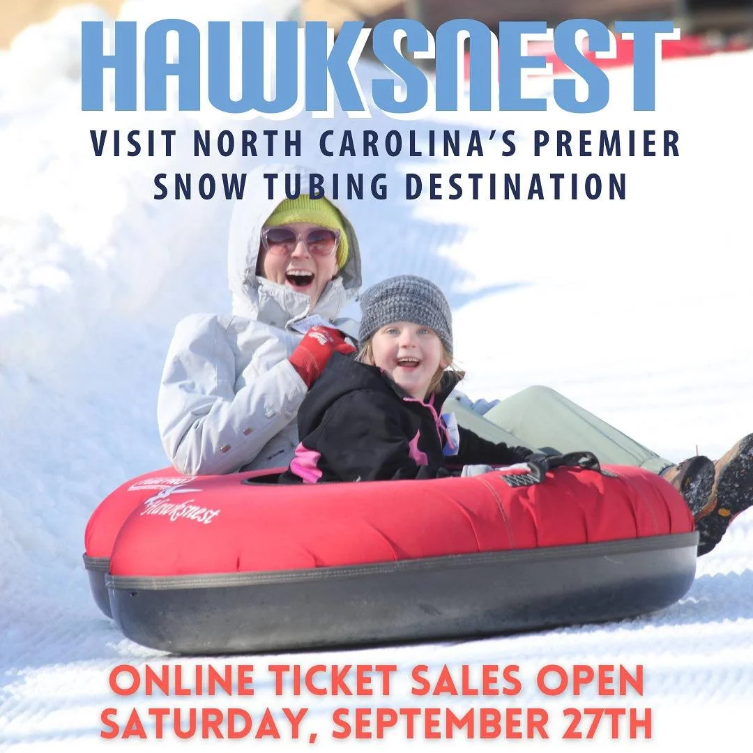 Hawksnest Adventures Snow Tubing child laughing on with mother on tube sliding down mountain Zipline Whitewater Seven Devils Boone NC