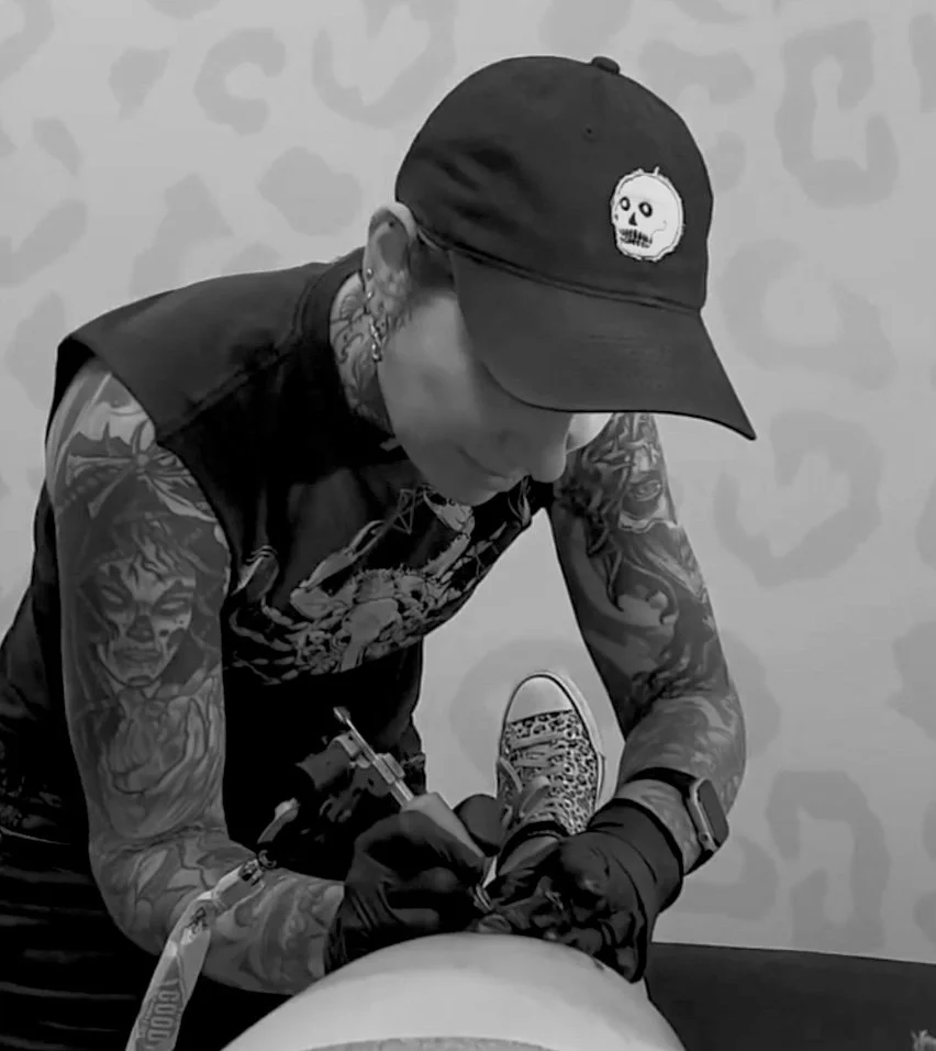 tattooing person in black and white