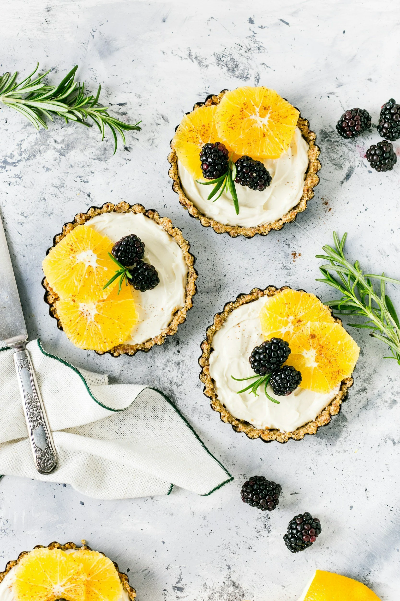 Lemon marscapone tarts topped with fresh blackberries.