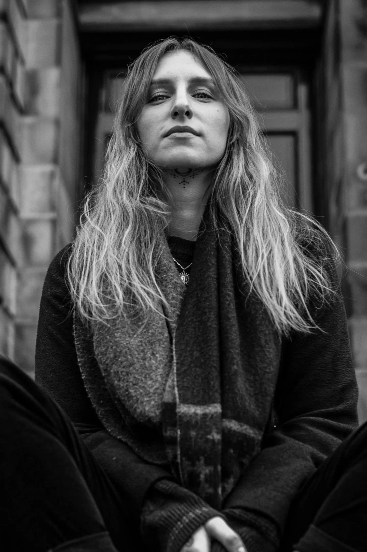 Black and white photograph showing Monika Malewska. She looks down to the camera, have long, blonde hair and calm face.