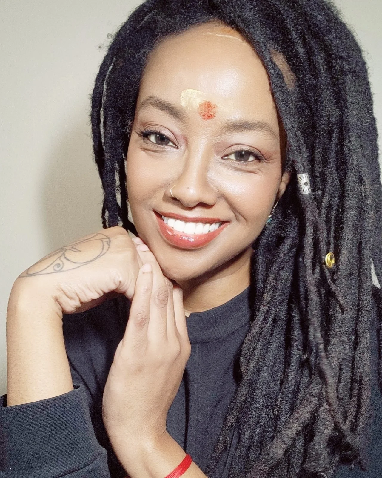 woman with locs, smiling
