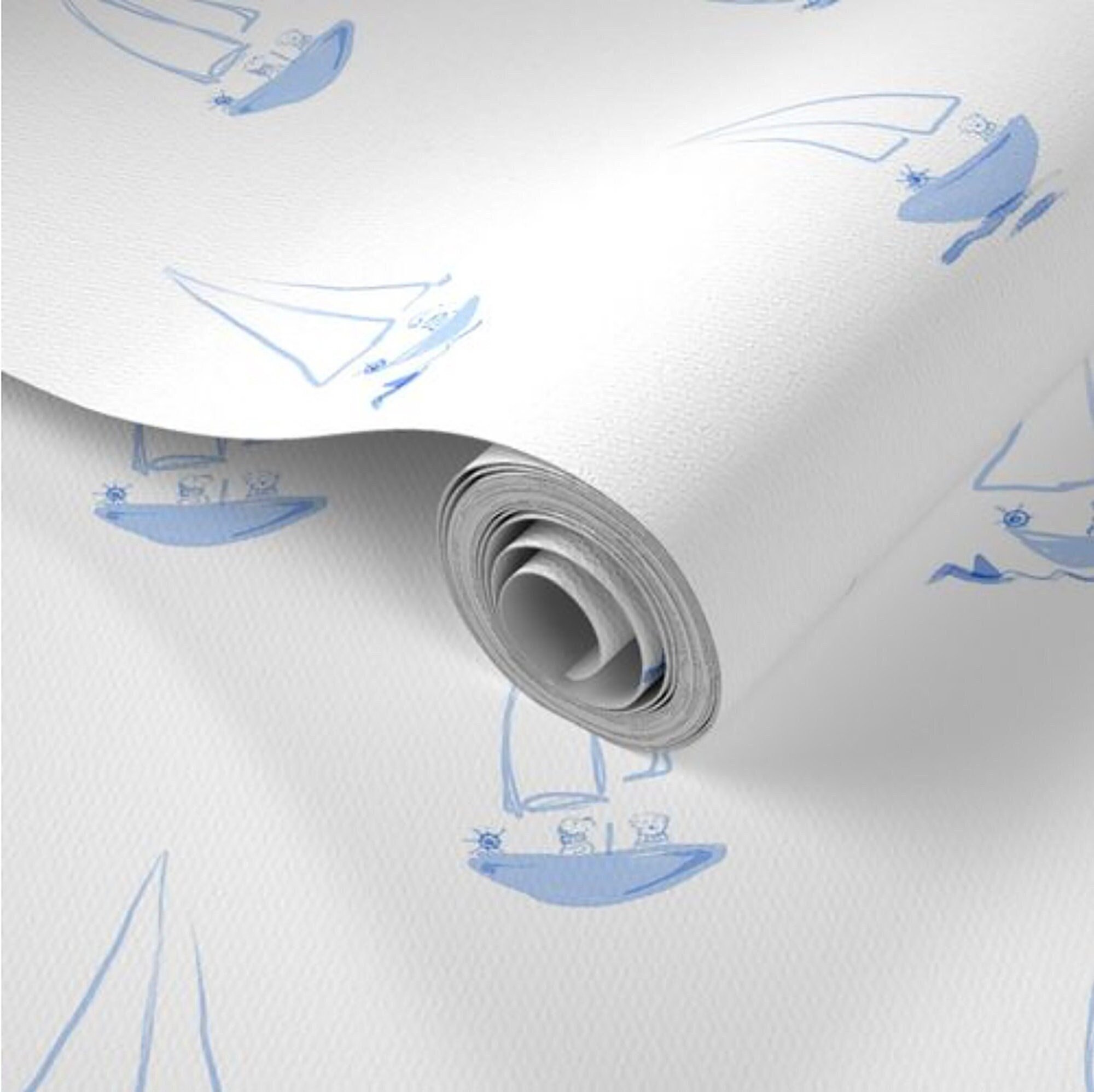 Peel and stick blue and white wallpaper featuring blue dogs in blue sailboats.