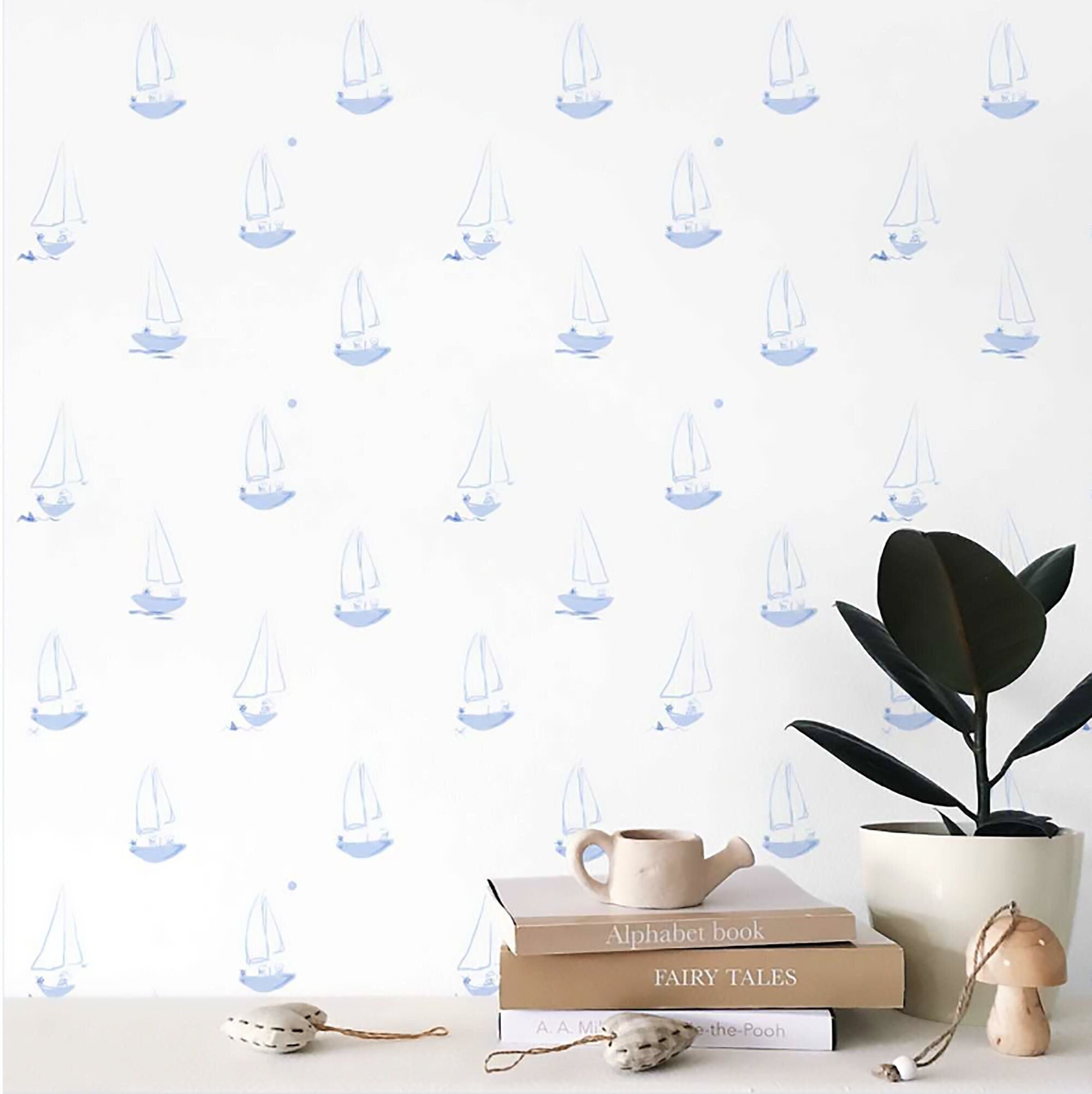 Peel and stick nursery wallpaper featuring blue sailor dogs in sailboats.
