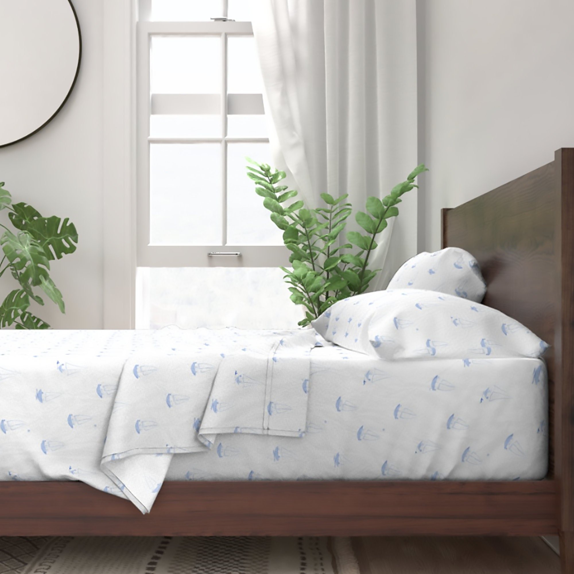Bed made with blue and white sailor pup sheets