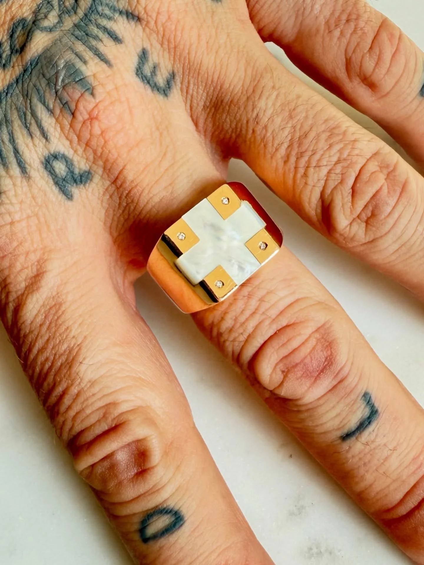 This ring is so amazing! The mother of pearl inlay cross is so magnificent, set on this rosy gold ring! Surrounded by 4 melee diamonds, the rings beauty speaks for itself! 

14K Vintage Mother of Pearl &amp; Diamond Ring - Size 10.5

$1,700