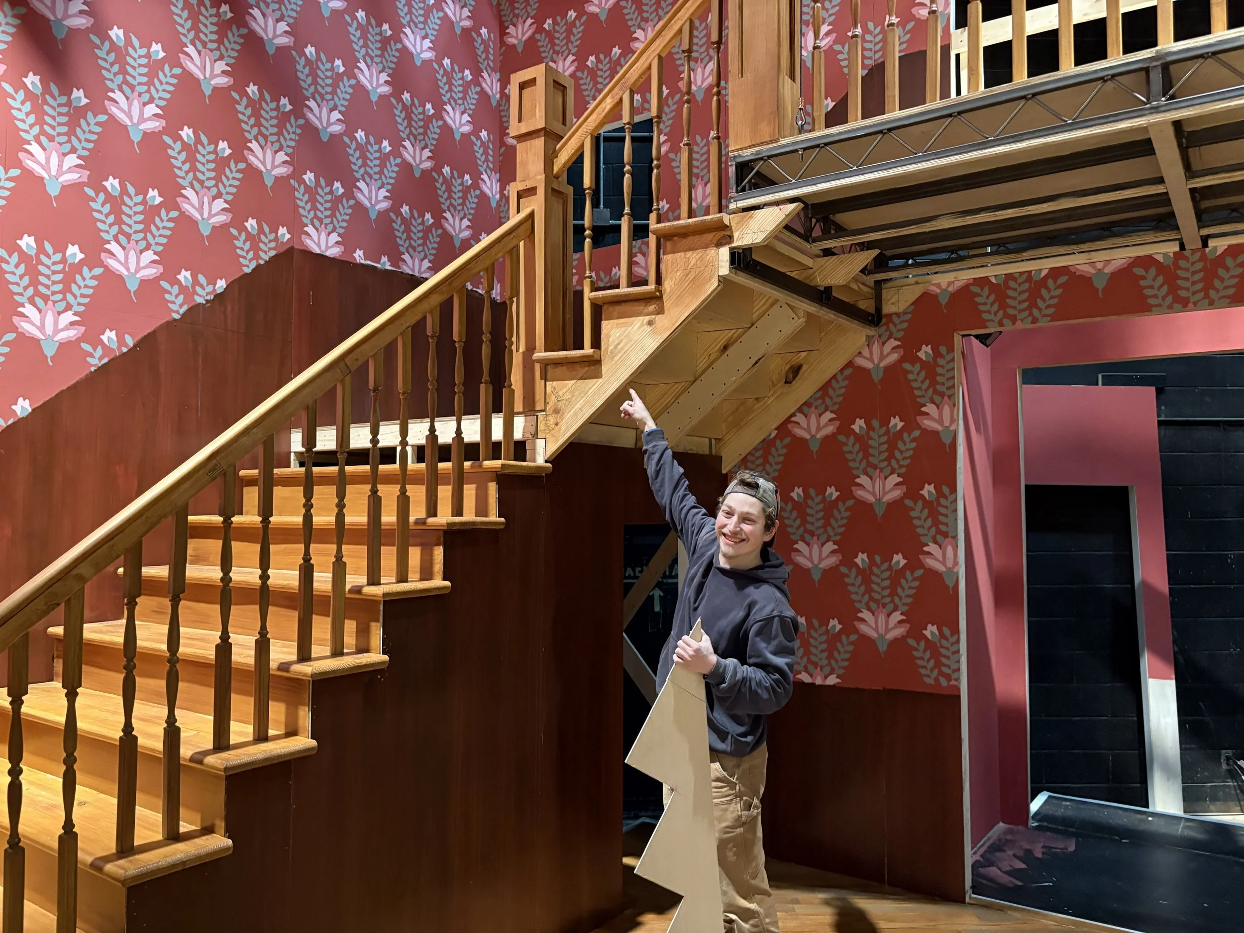 The upstage edge of the truss platform was supported by structural flats, while the downstage edge was hung from aircraft cable.  The upper section of the staircase was hung from a welded steel hanger.