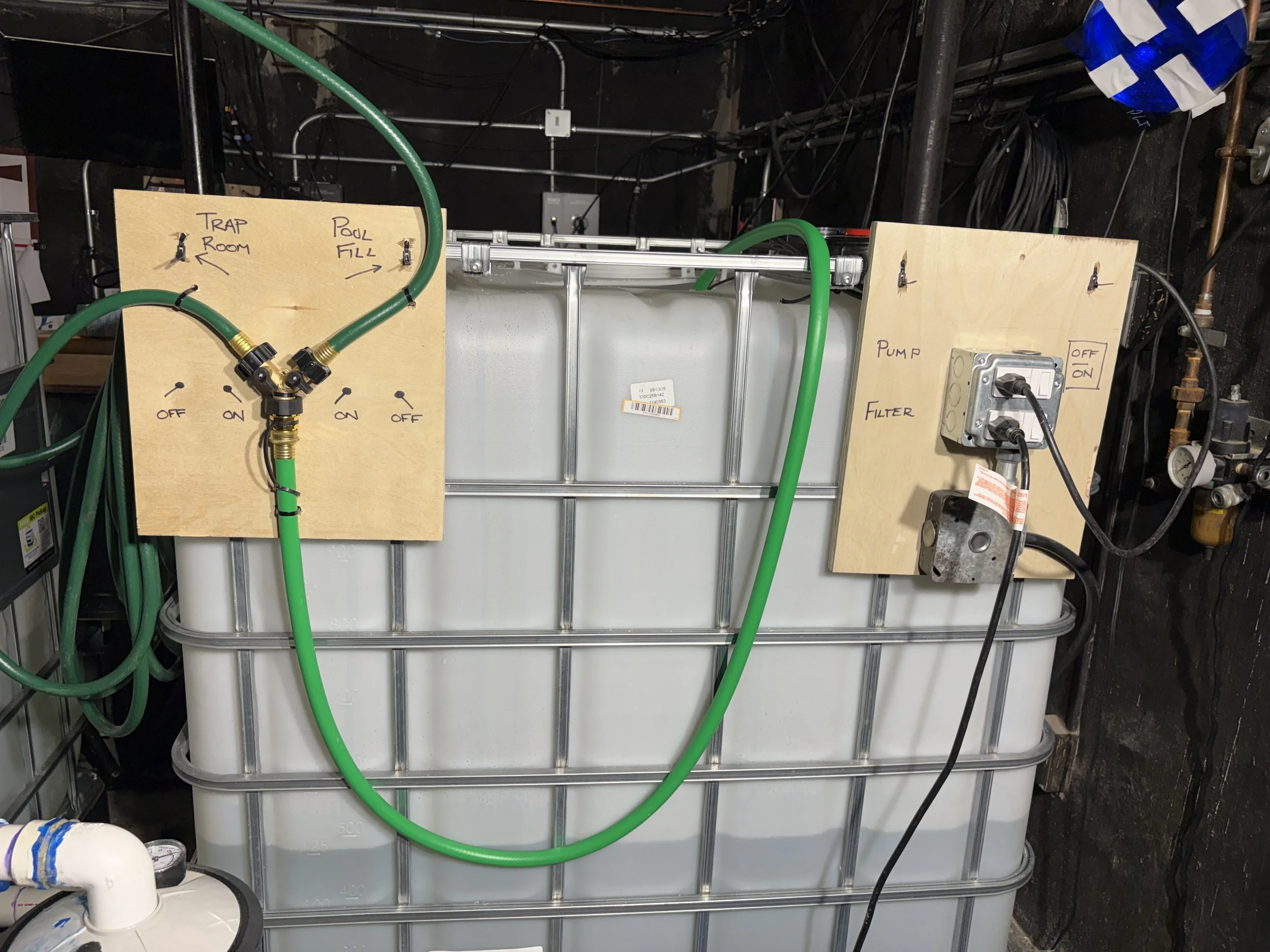 A view of one of the IBC totes showing switches and water controls