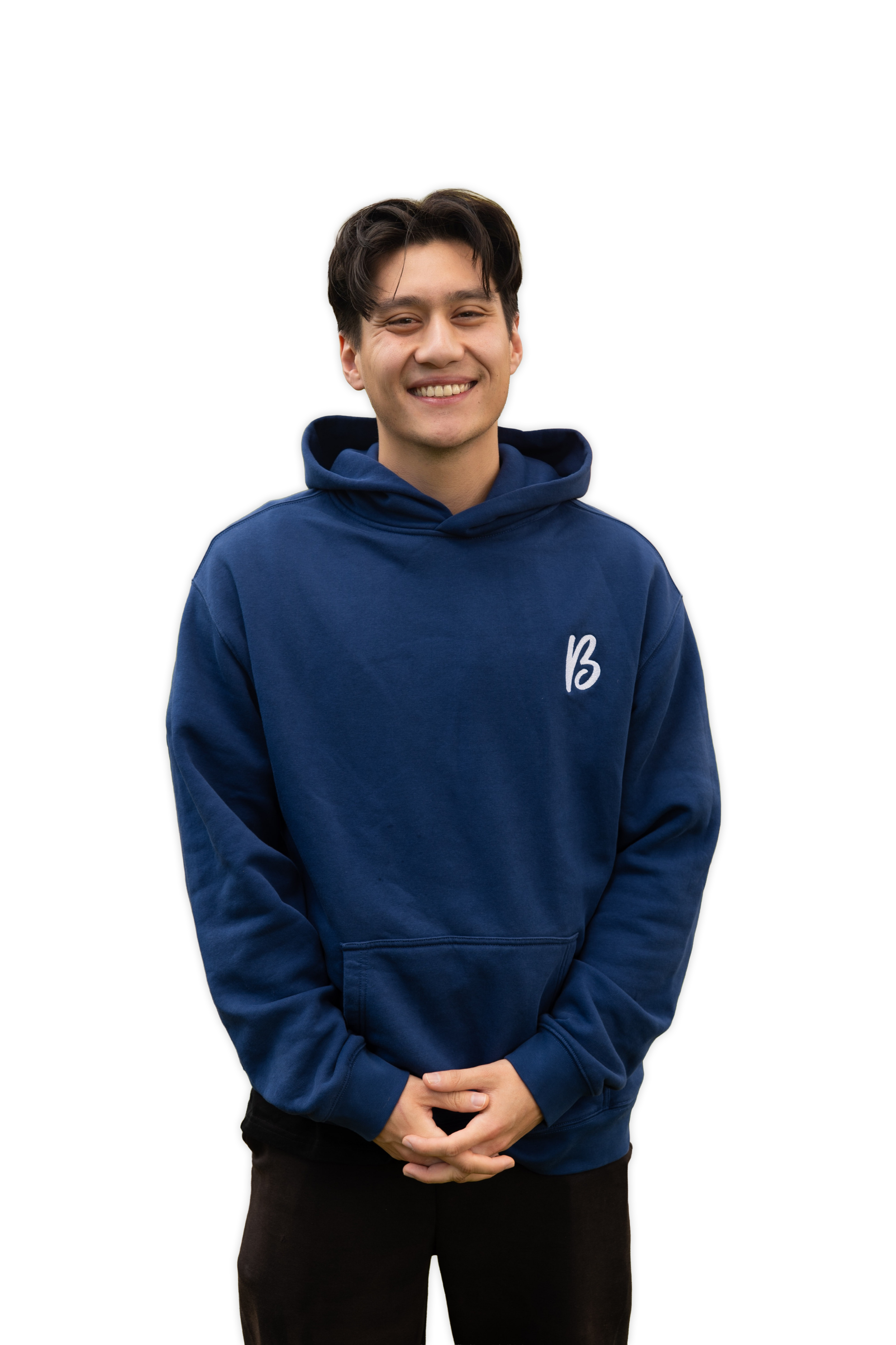 Smiling young man in a blue hoodie with a logo, standing against a black background.