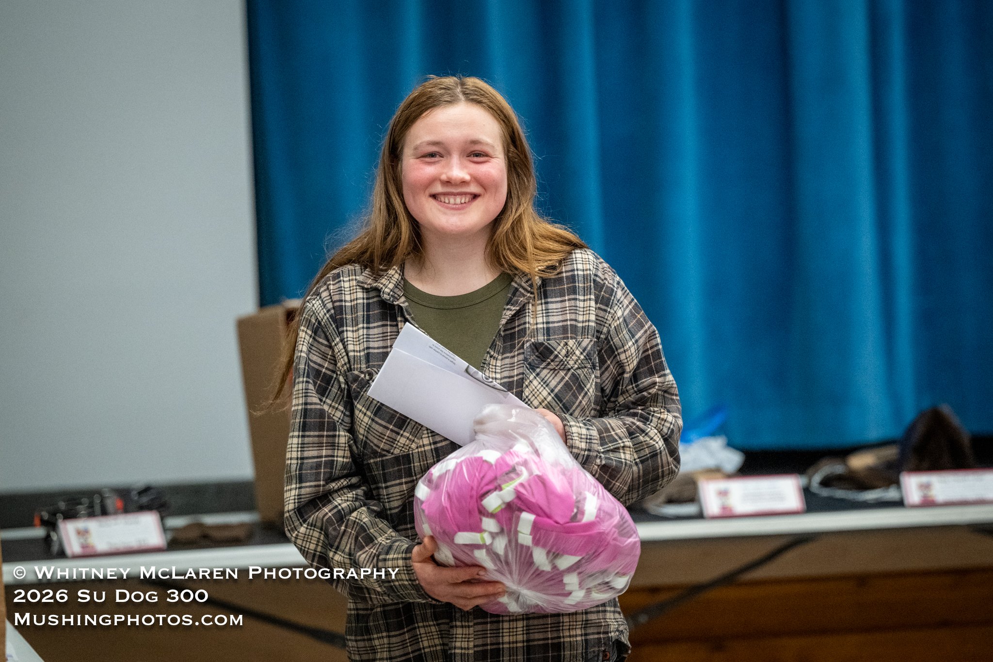 Talia Marten chooses a sack of dog booties for her team
