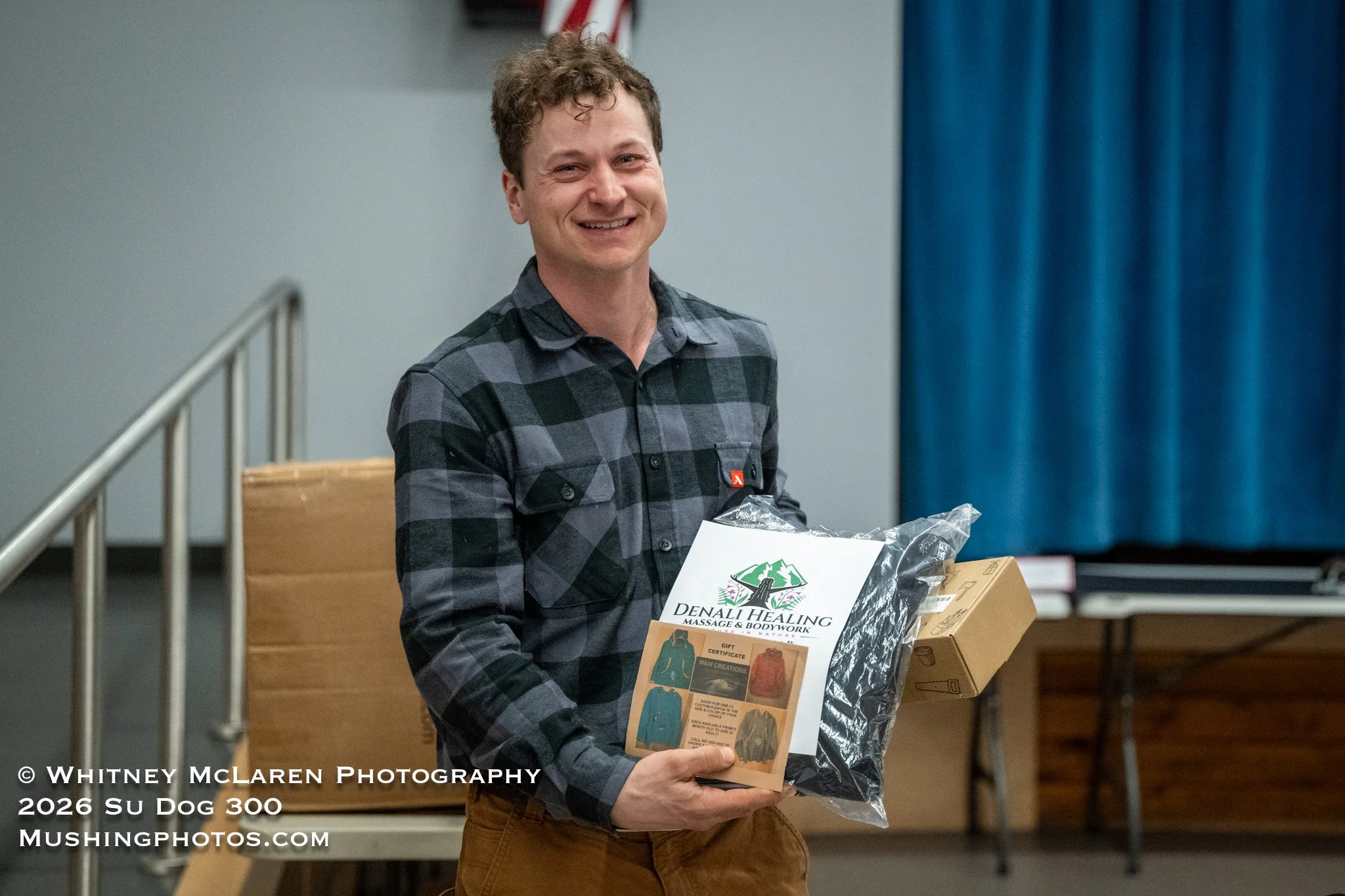 Rohn Buser pampering himself with a free massage from Denali Healing, certificate for a custom-made Kuspuk by Marilyn Mapes, some garden tools and a Su Dog sweatshirt