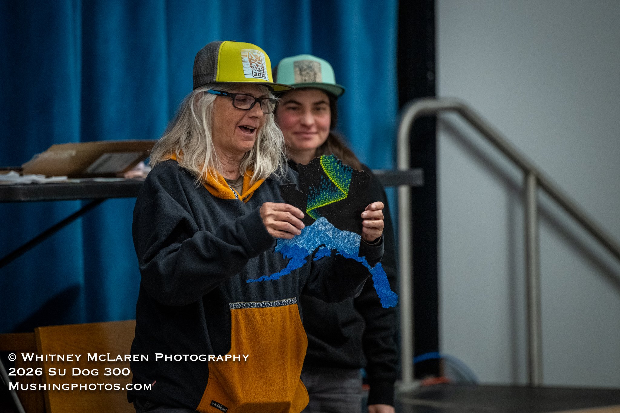 Race Marshall Donna receives a hand-painted wooden Alaska for her dedication to Su Dog 300
