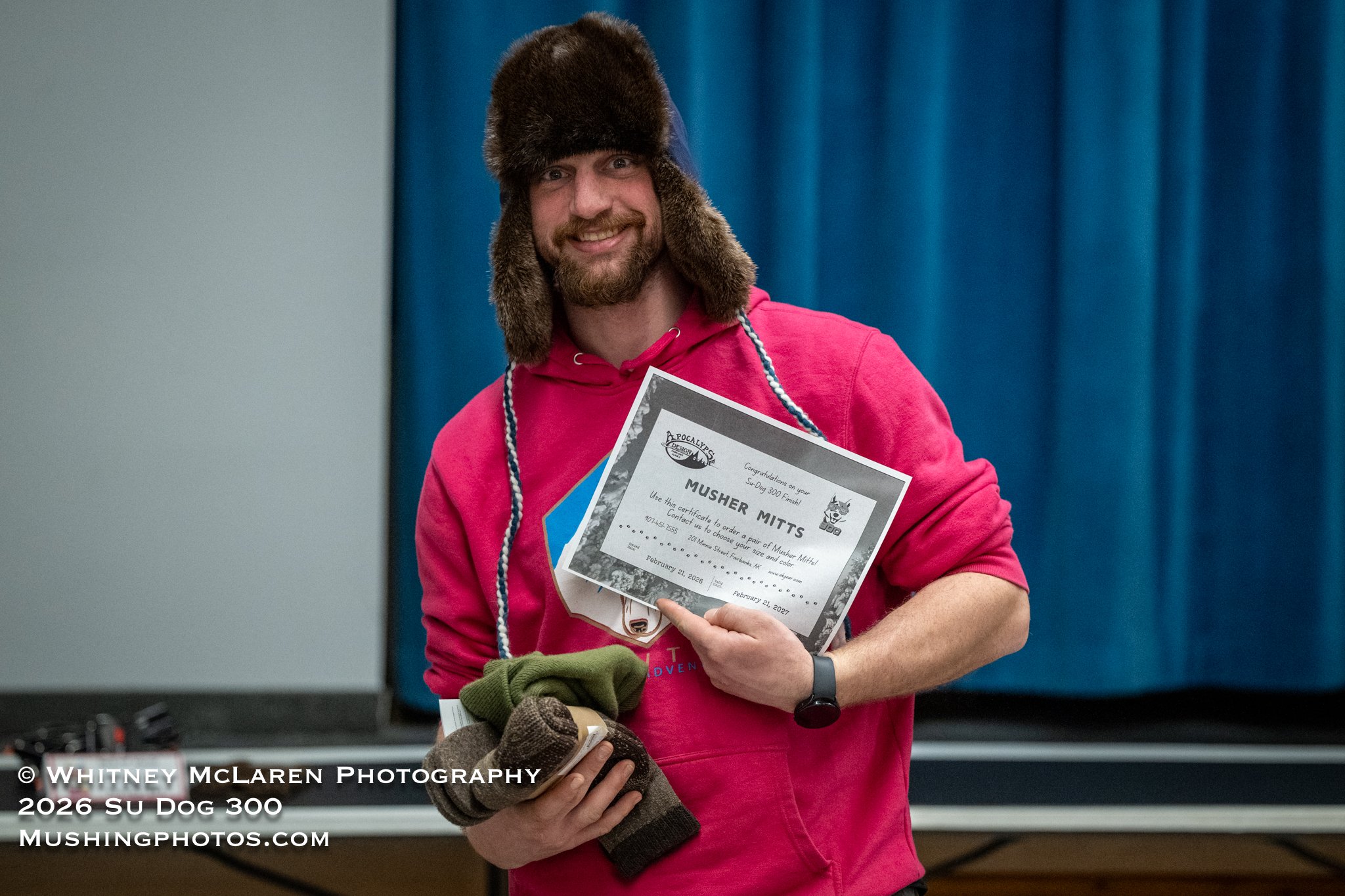 Mike Dolinar snags a certificate for custom Apocalypse Designs musher mitts and some Buffalo Wool gear