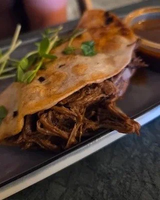 Dip. Bite. Repeat. That&rsquo;s the birria rhythm at Los Muchachos. Come get messy with the taco everyone&rsquo;s talking about! 😋🌮