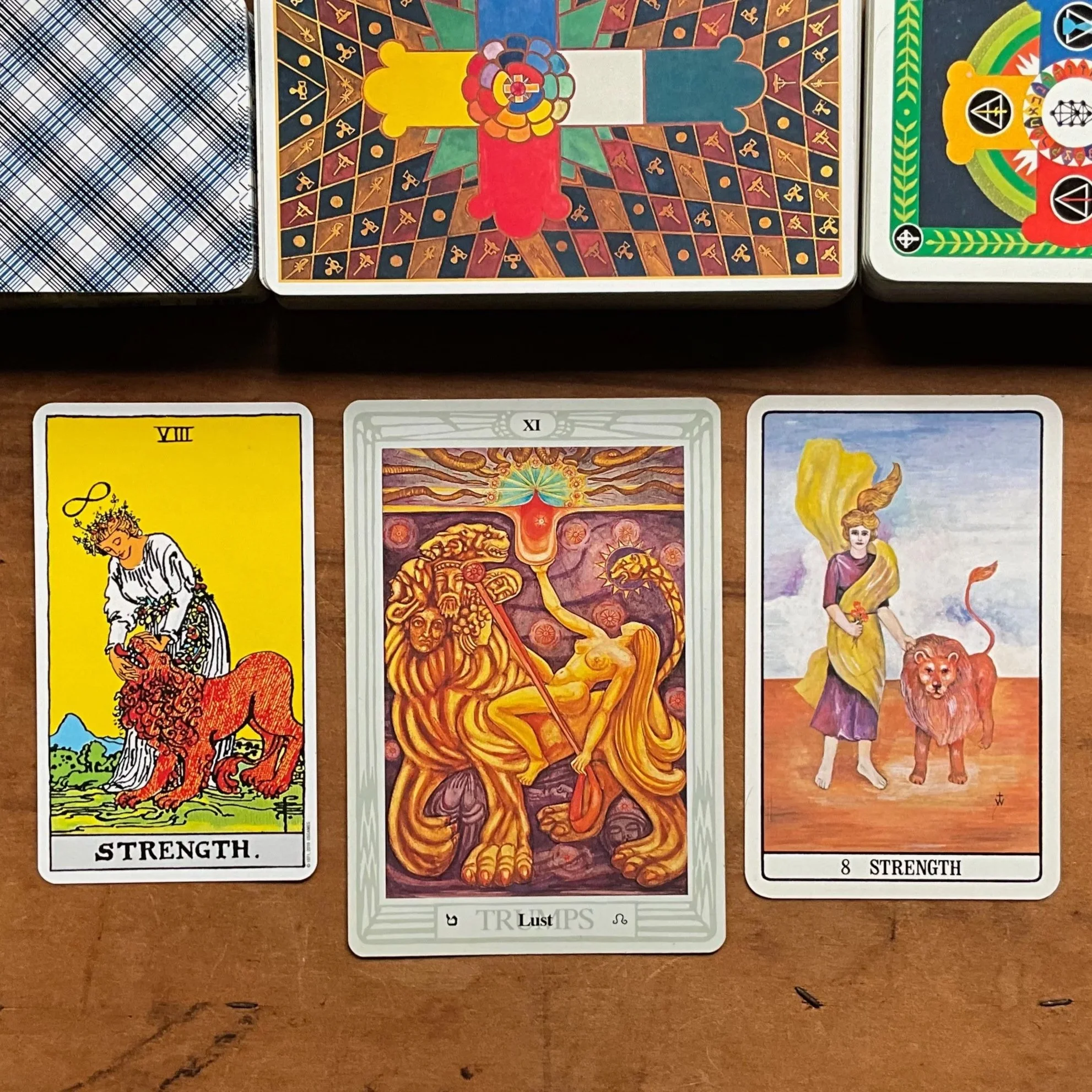 VIII. Strength and XI. Lust from The Rider-Waite, Thoth, and Golden Dawn tarot decks.